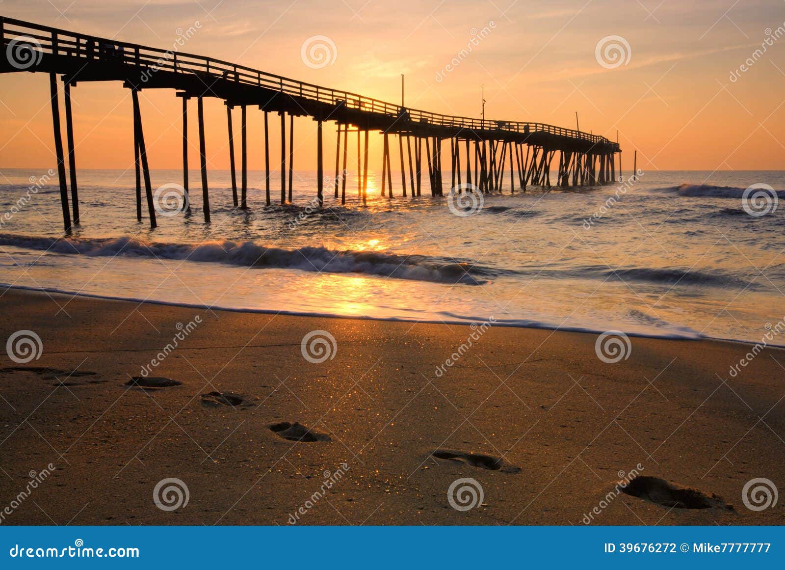 sunrise and footprints on the outer banks, north carolina