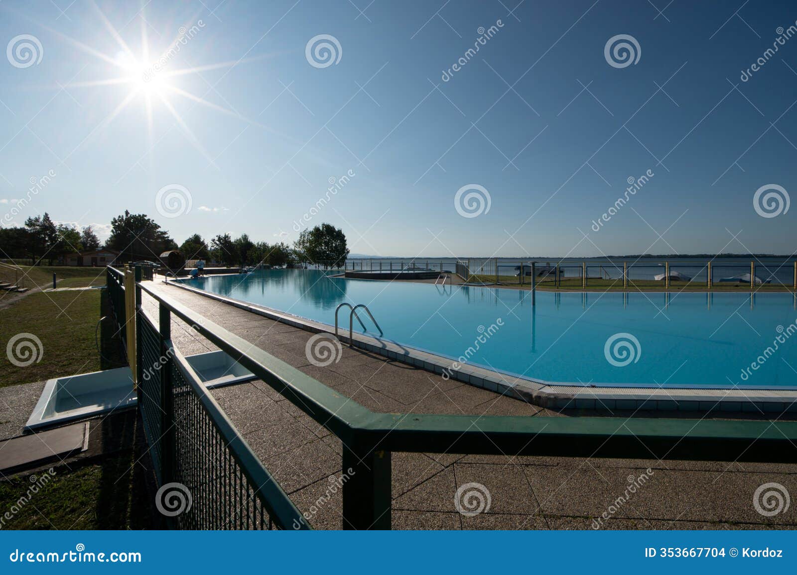 sunrise over swimming pool in klokocov autocamping by zemplinska sirava dam