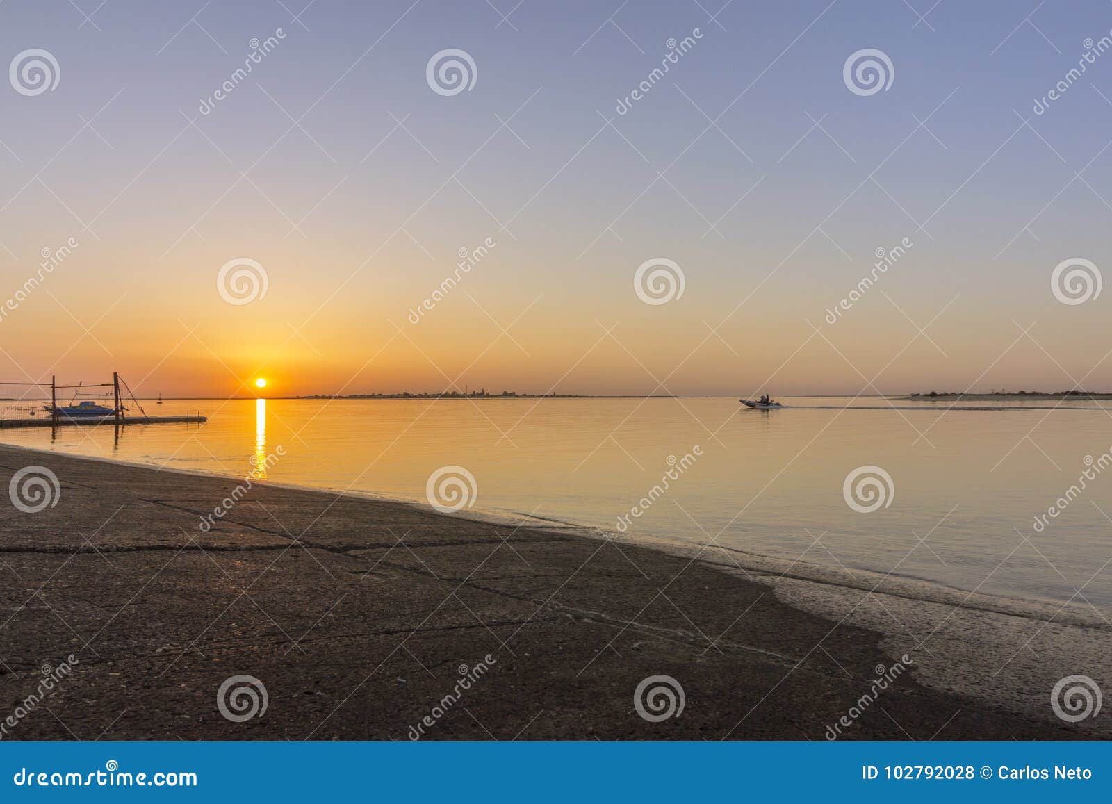 sunrise aerial seascape view of olhao dockyard, waterfront to ria formosa natural park with armona island in background