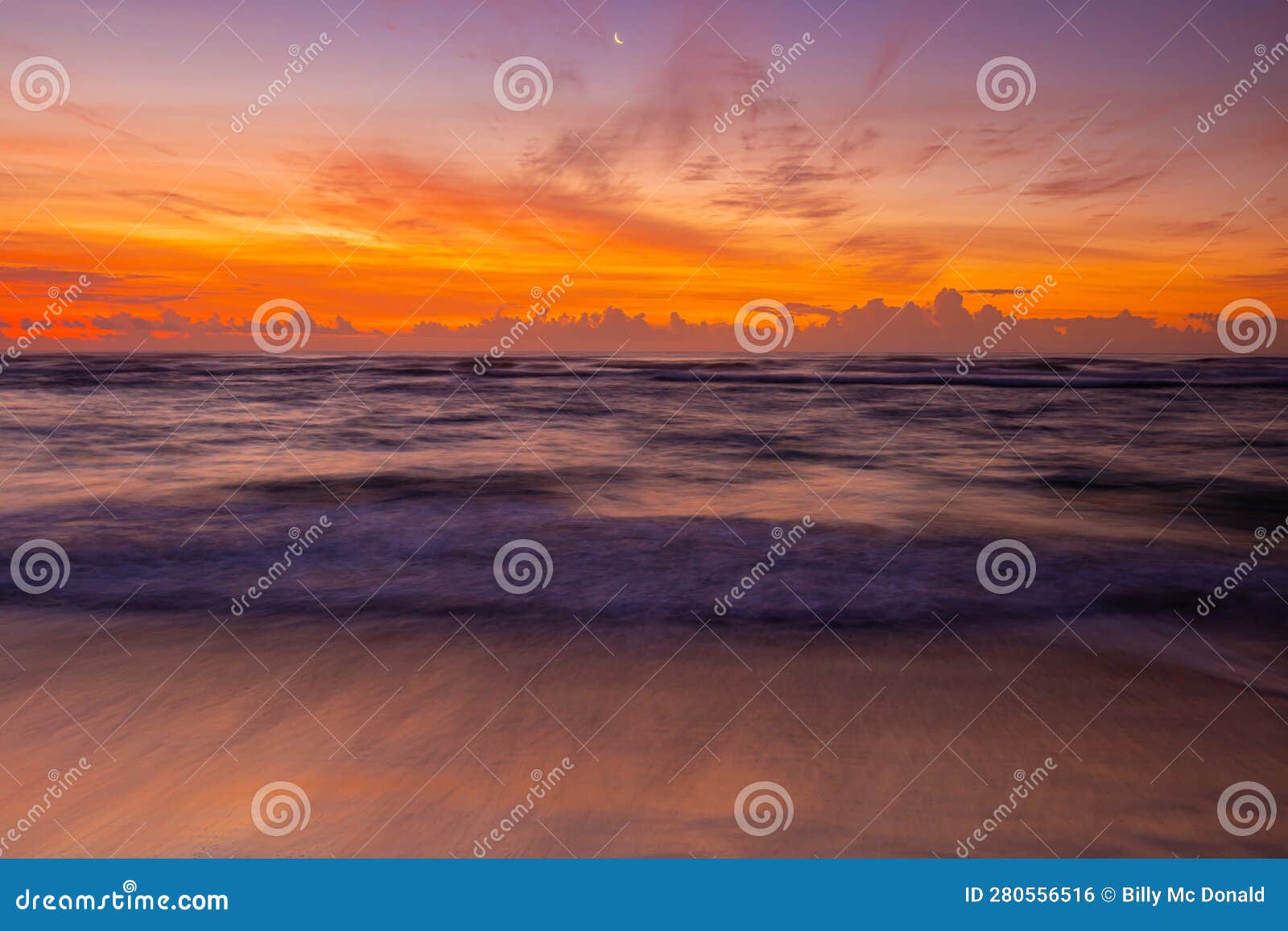 sunrise on the waves and the sandy shore of lydgate beach