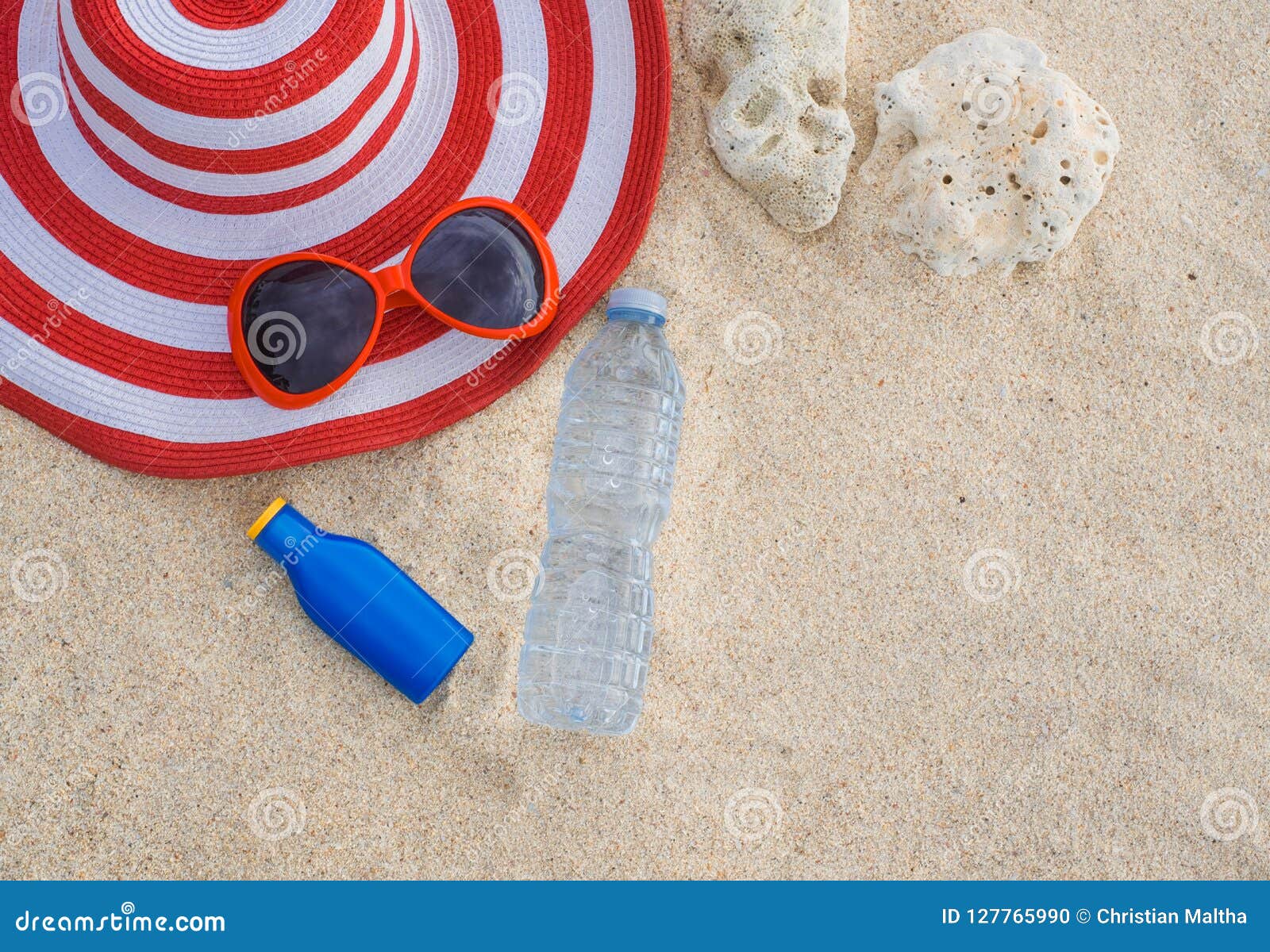 Sunscreen, Hat, Sunglasses And Bottle Of Water On Sand Beach Stock ...