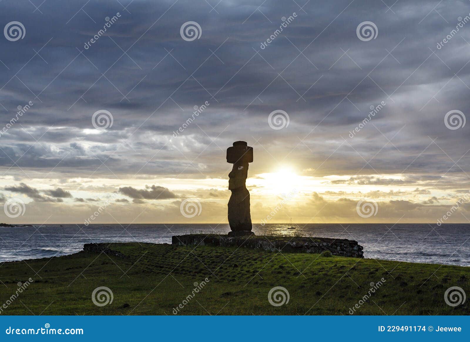 sunset at ahu tahai, site with moai statues at easter island, chile