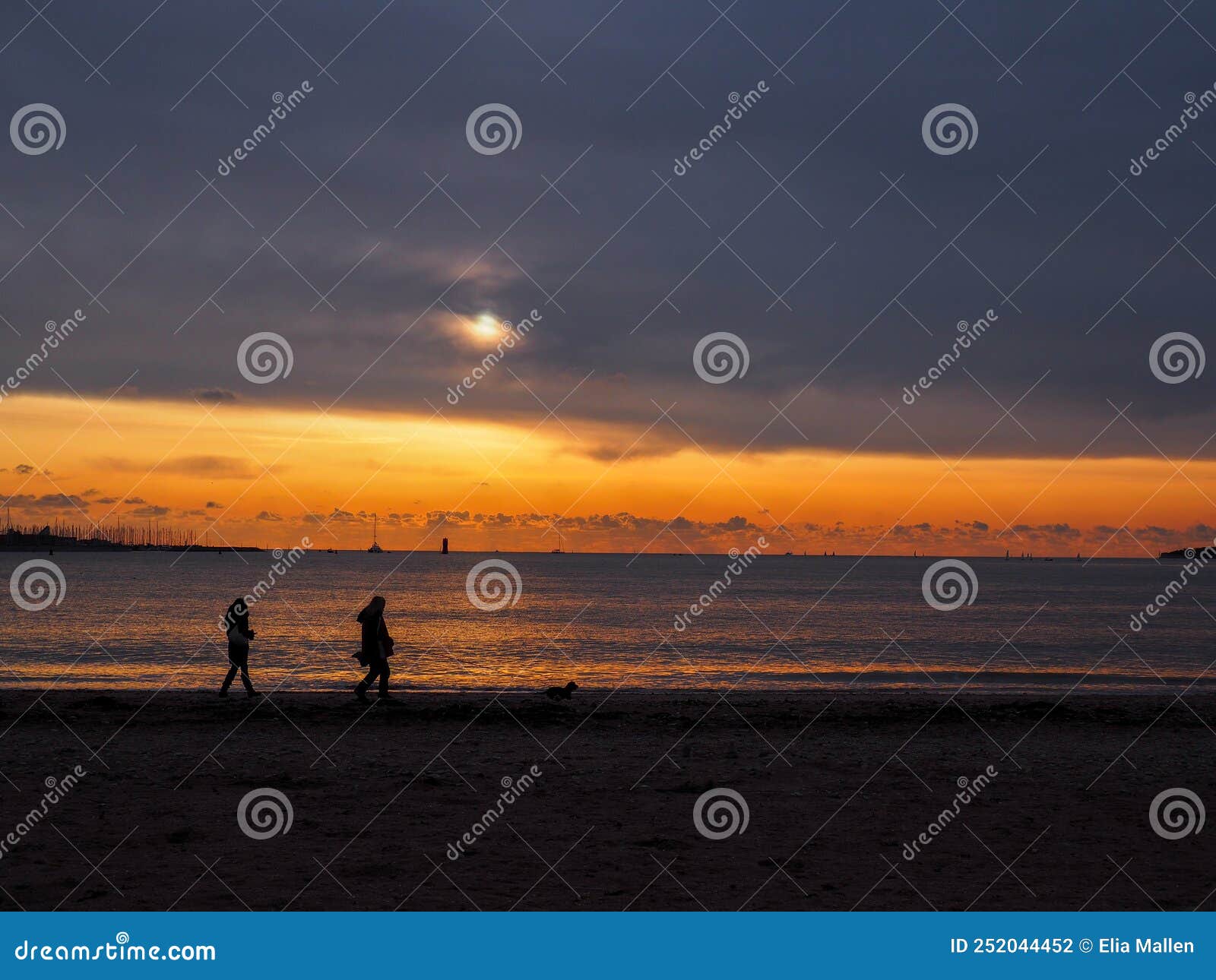 Sunset at the Beach with People Passing by Stock Photo - Image of beach ...