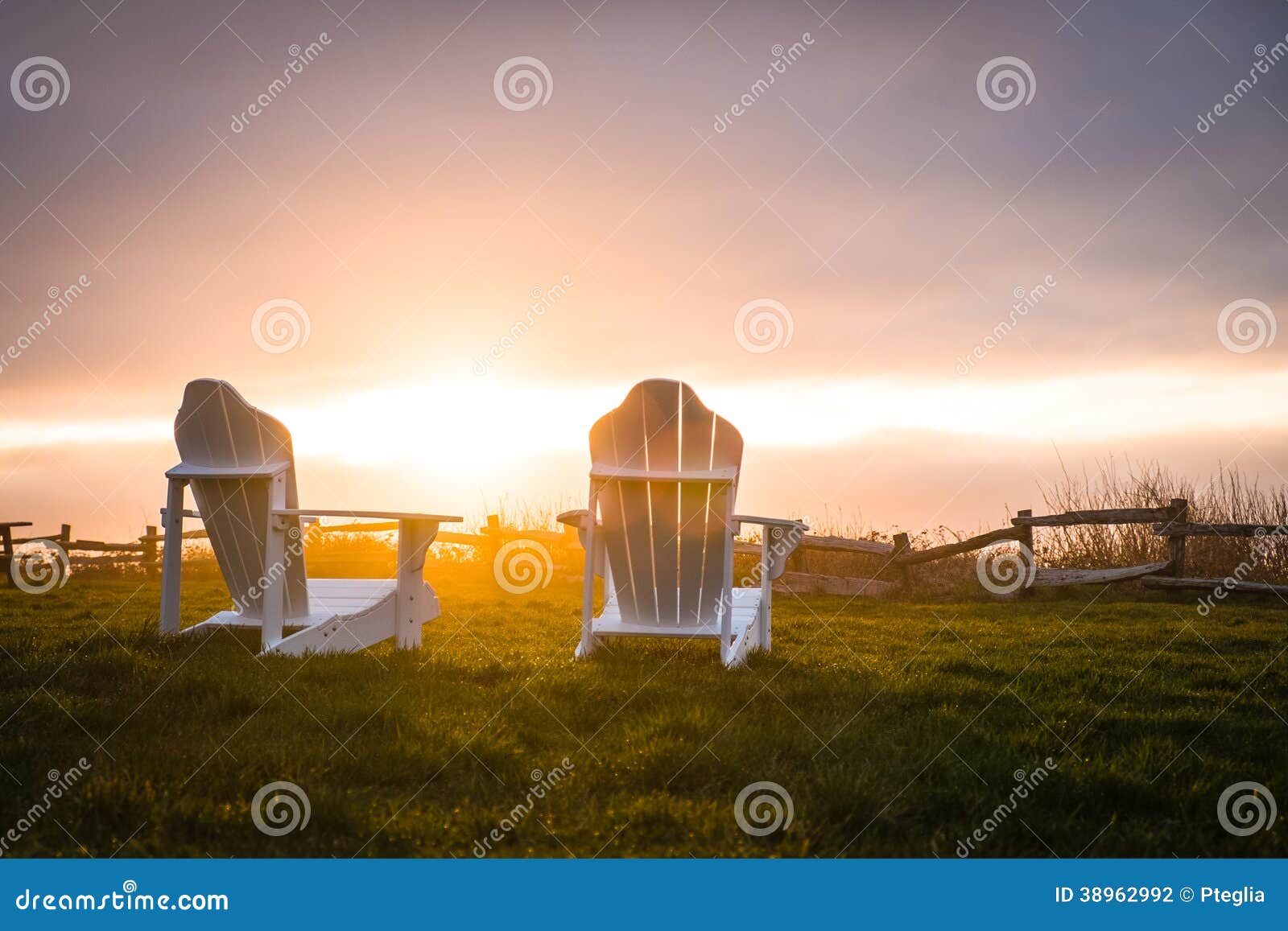 brilliant sunset over fence and chairs