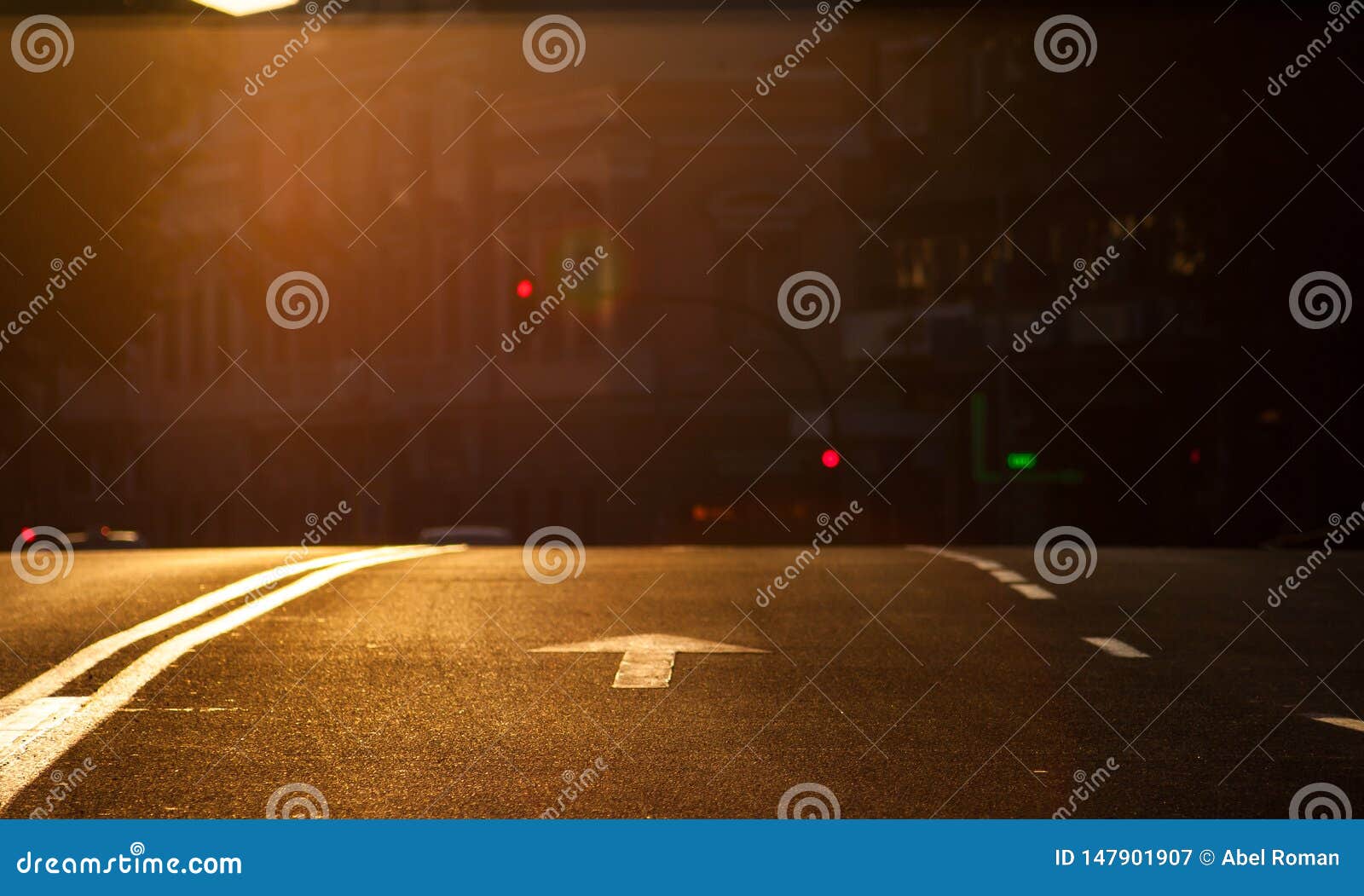 sunset in the city. arrow signaling of vehicles in an urban environment with traffic lights and a change of grade