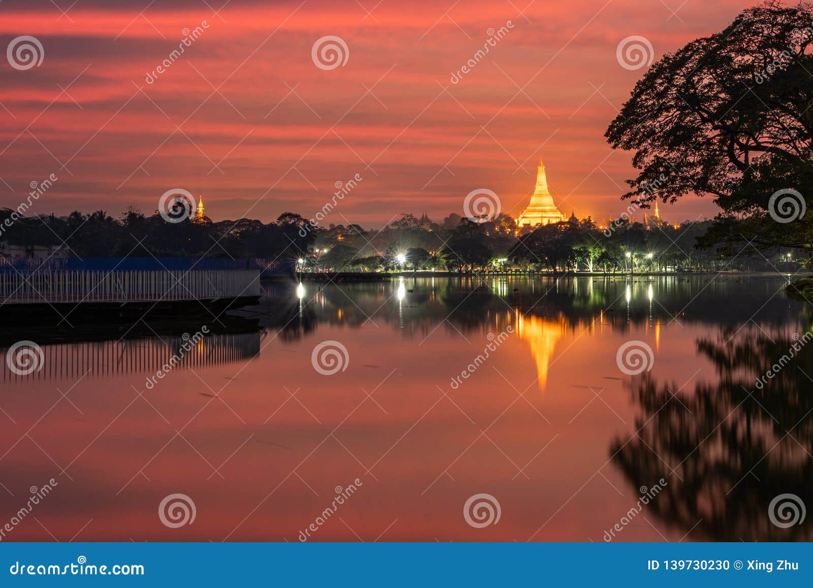 sunset in the front of the lake, view of shwedagon pagoda, yangon, myanmar. burma asia. buddha pagoda