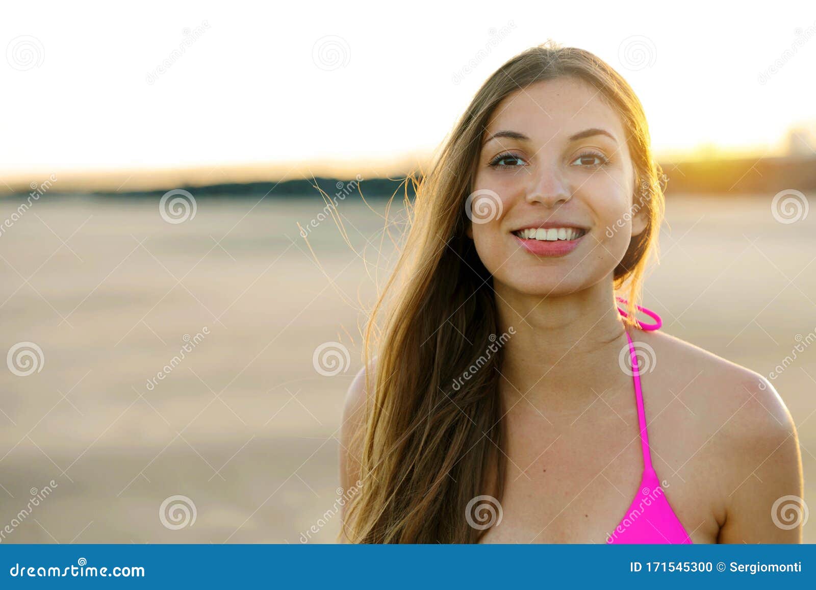 Sunset Girl on the Beach Looking at Camera. Copy Space Stock Photo