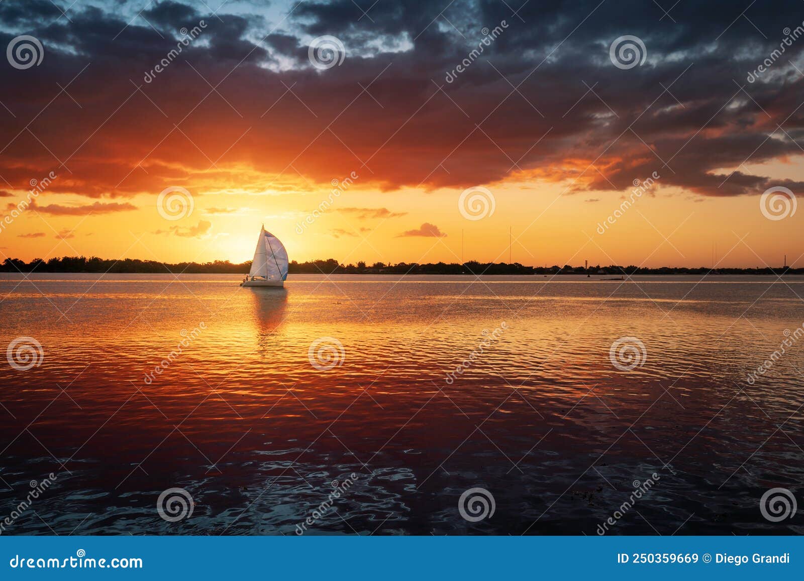 sunset at guaiba river with sail boat - porto alegre, rio grande do sul, brazil
