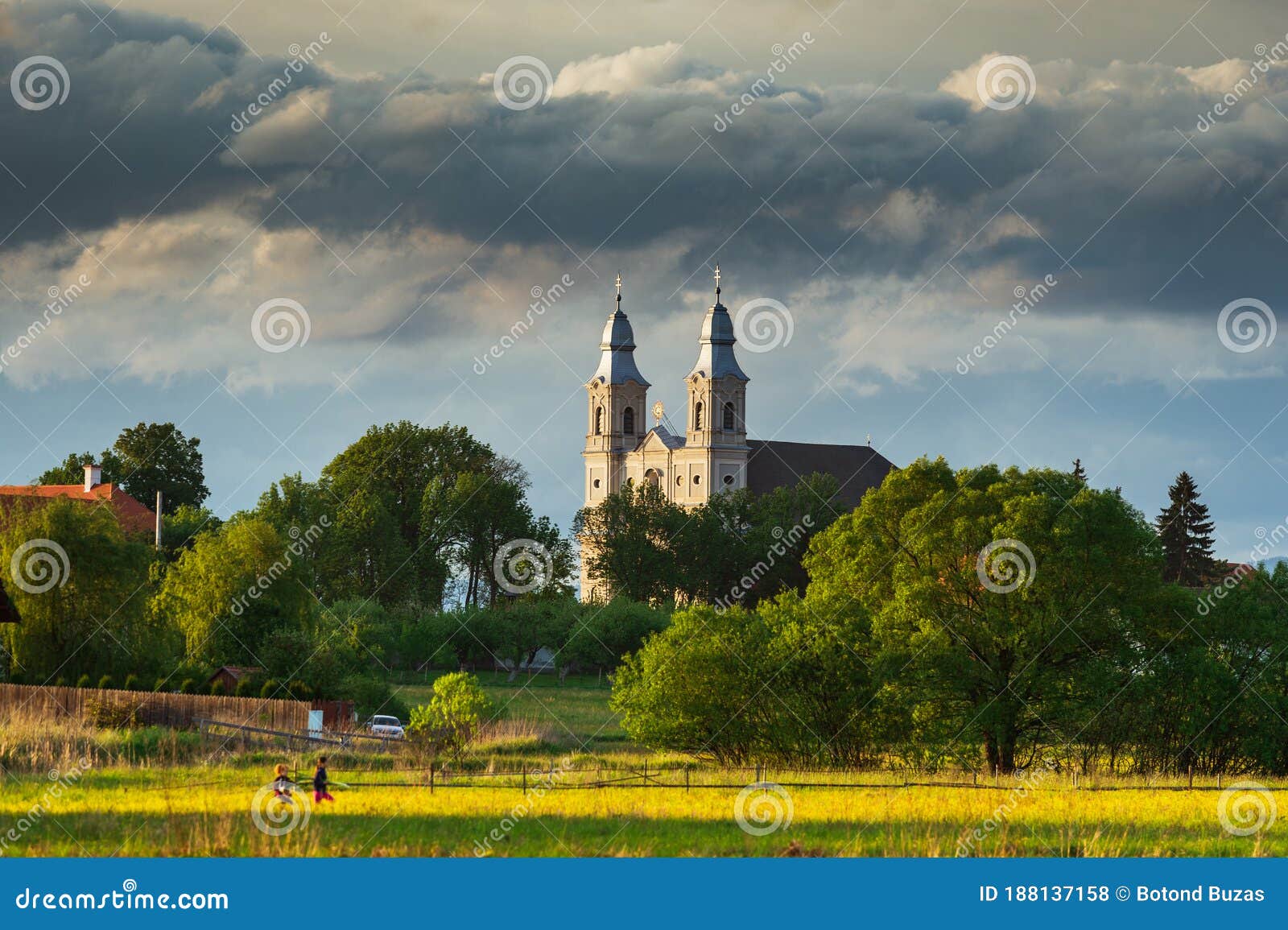 catholic church with two towers in the orange sunset. taken in csiksomlyo, hargita county, romania.