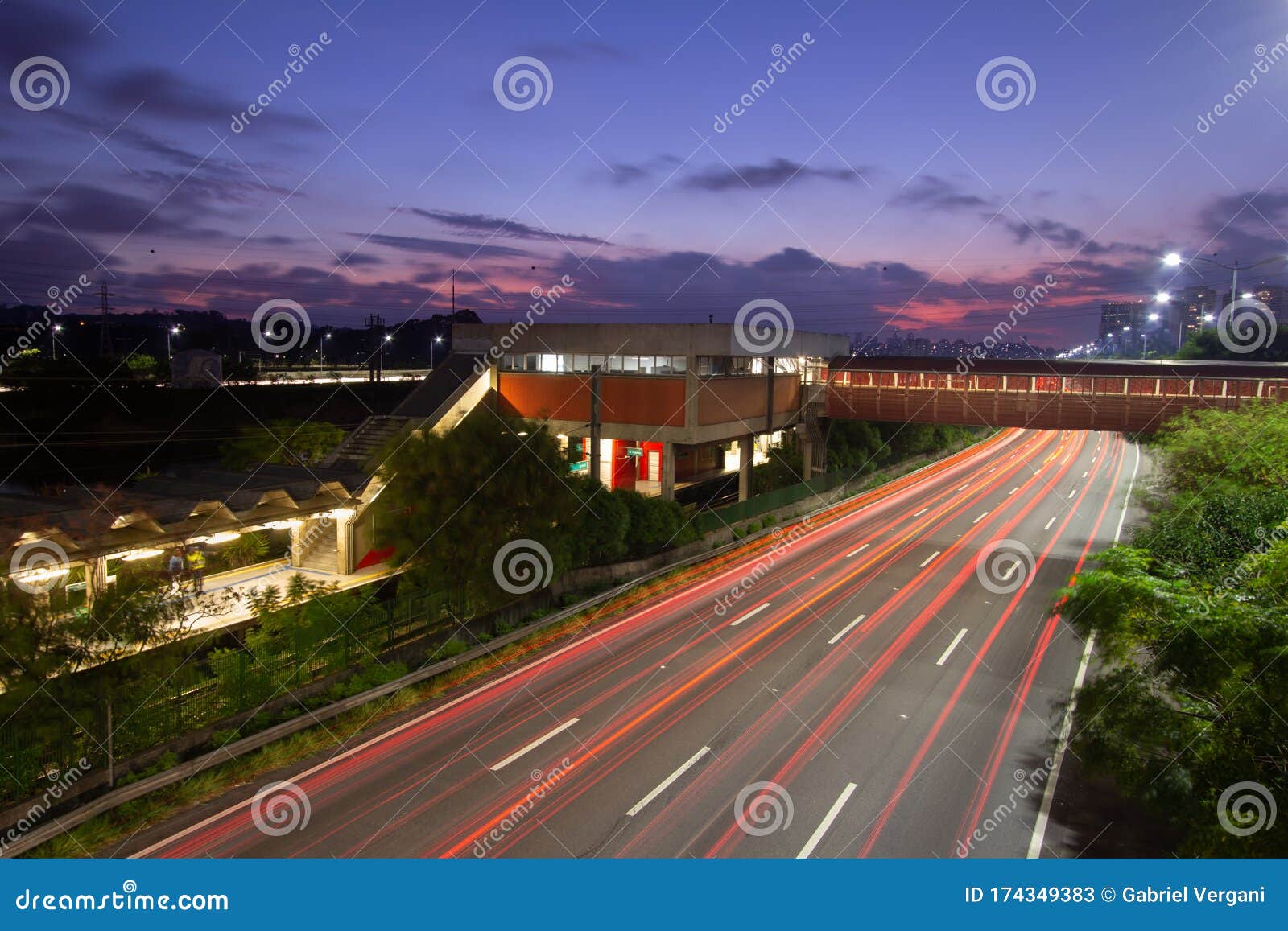 the night in metropolis, train station and vehicles in transit. sao paulo city highway beside the river. skyline, cars and