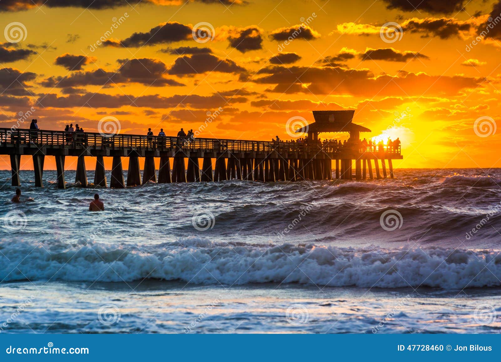 sunset over the fishing pier and gulf of mexico in naples, florida.