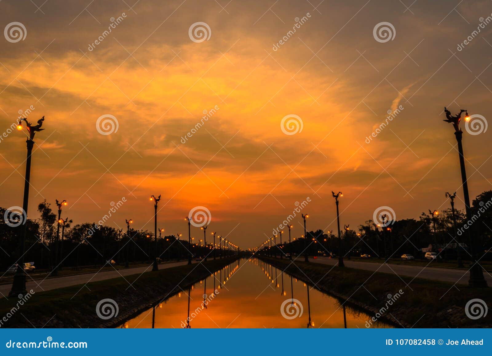 Sunset Over a Highway Utthayan Road and Reflection on the River. Stock