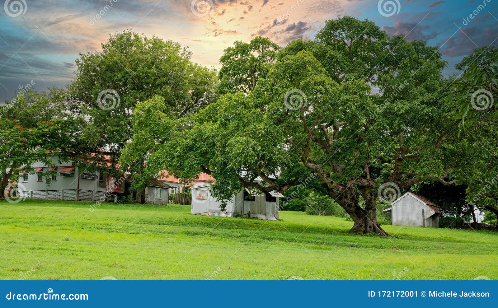 Sunset Over Historic Homestead. Sunset over an historic homestead set in parkland amongst lush green grass