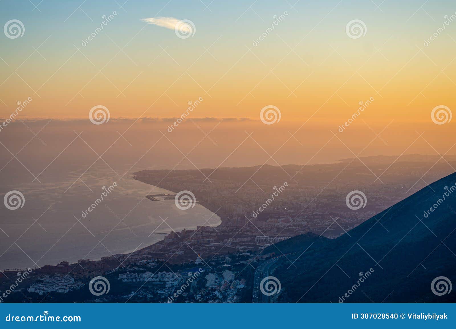 sunset over mediterranean sea and fuengirola from calamorro peak