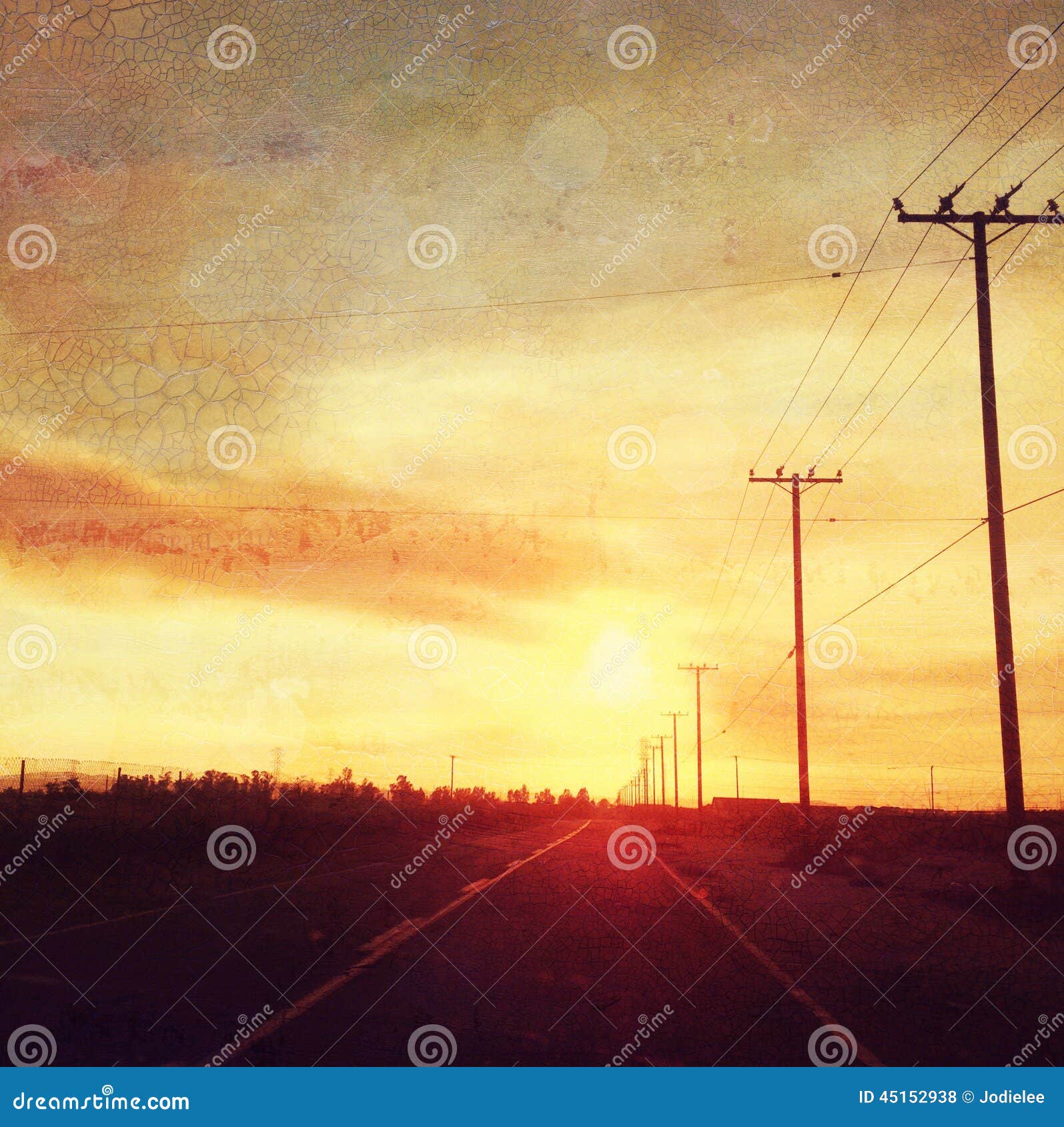 sunset over road with telegraph poles country scene