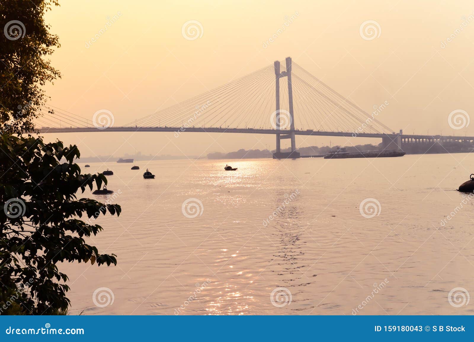 sunset over vidyasagar setu a modern cantilever spar cable-stayed bridge in a summer evening on the river hooghly. silhouette