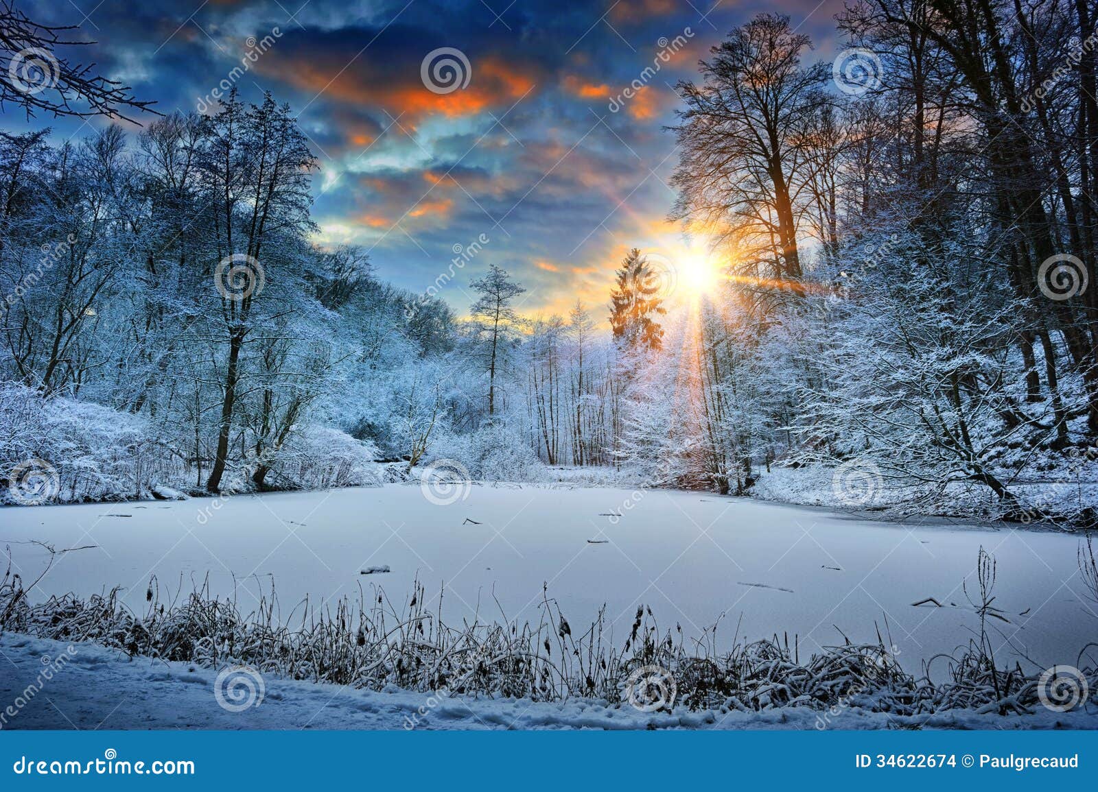 sunset over winter forest lake