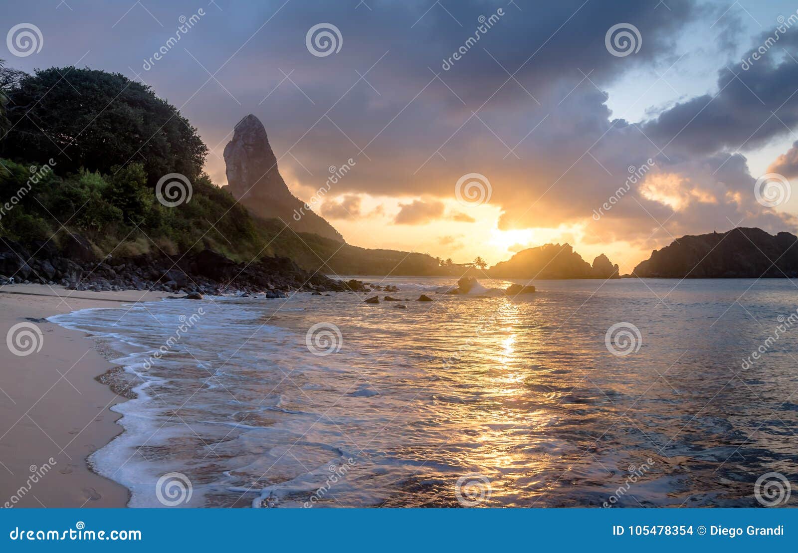 sunset at praia do cachorro beach with morro do pico on background - fernando de noronha, pernambuco, brazil