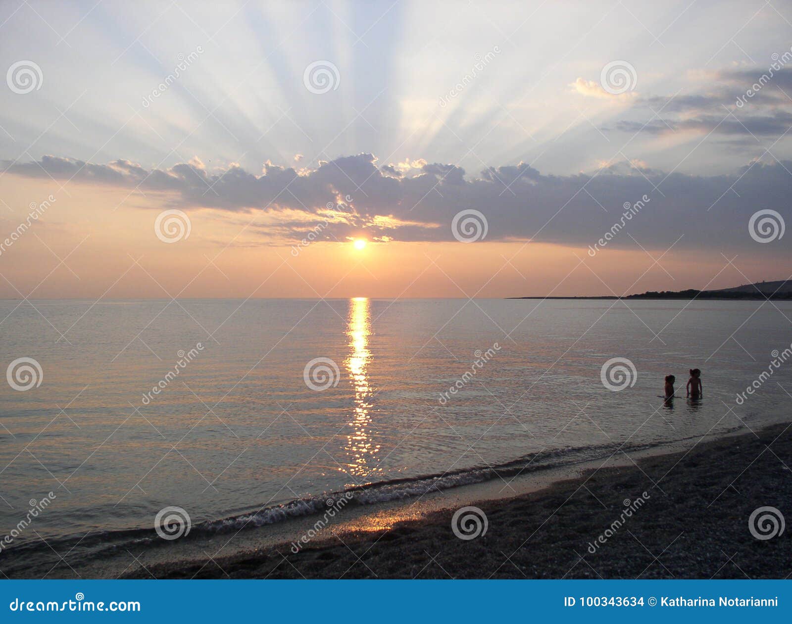 sunset rays beach scene on the mediterranean sea