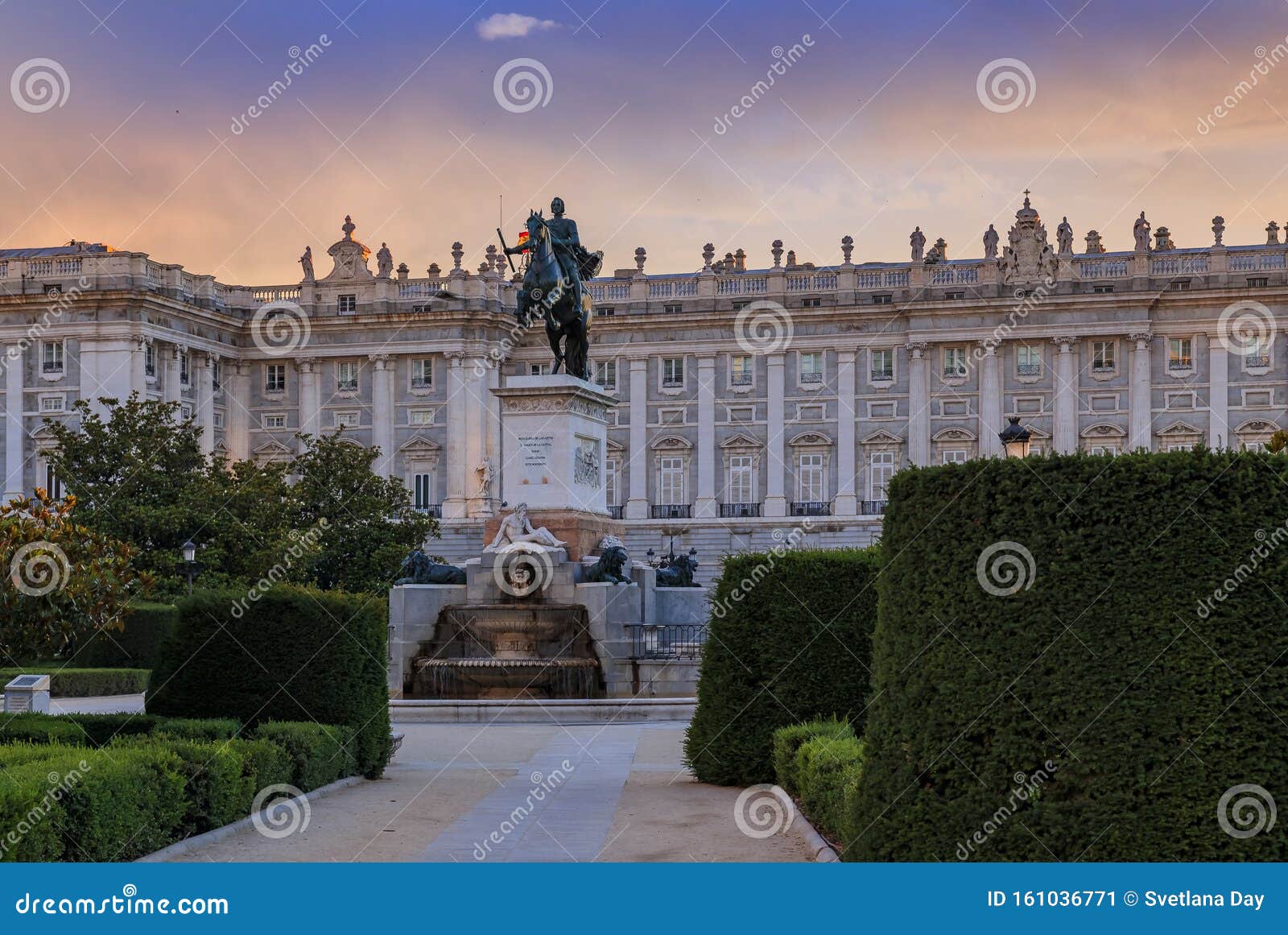 sunset by the royal palace or palacio real with king philip iv statue in plaza de oriente in madrid spain built in 1639