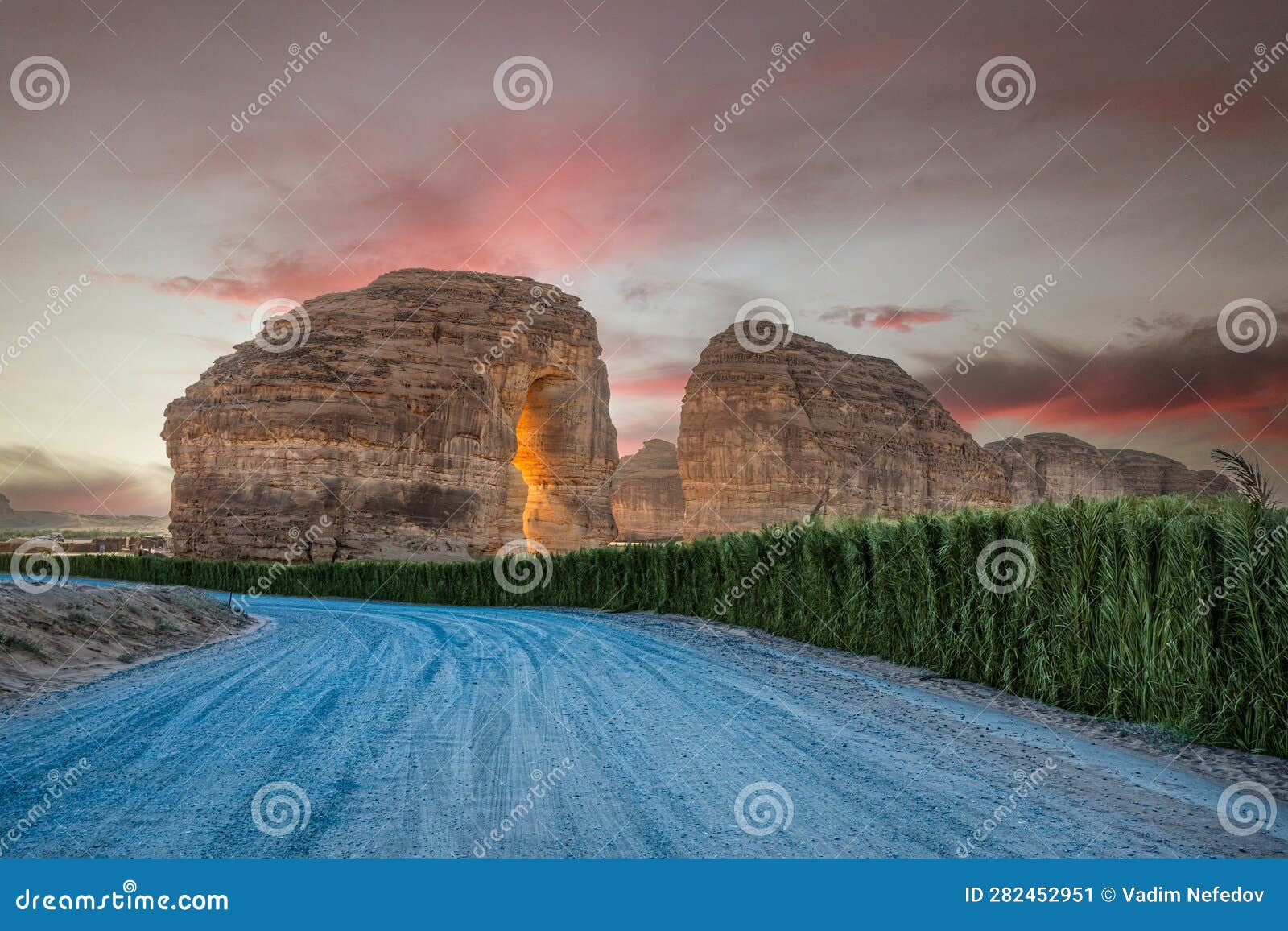 sunset sandstone elephant rock erosion monolith standing in the desert, with road in foreground, al ula, saudi arabia