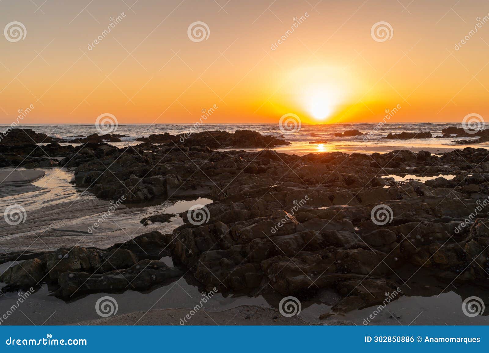 sunset and seascape with rock formation in at apulia beach. parque natural do litoral on the north of portugal in the vicinity of