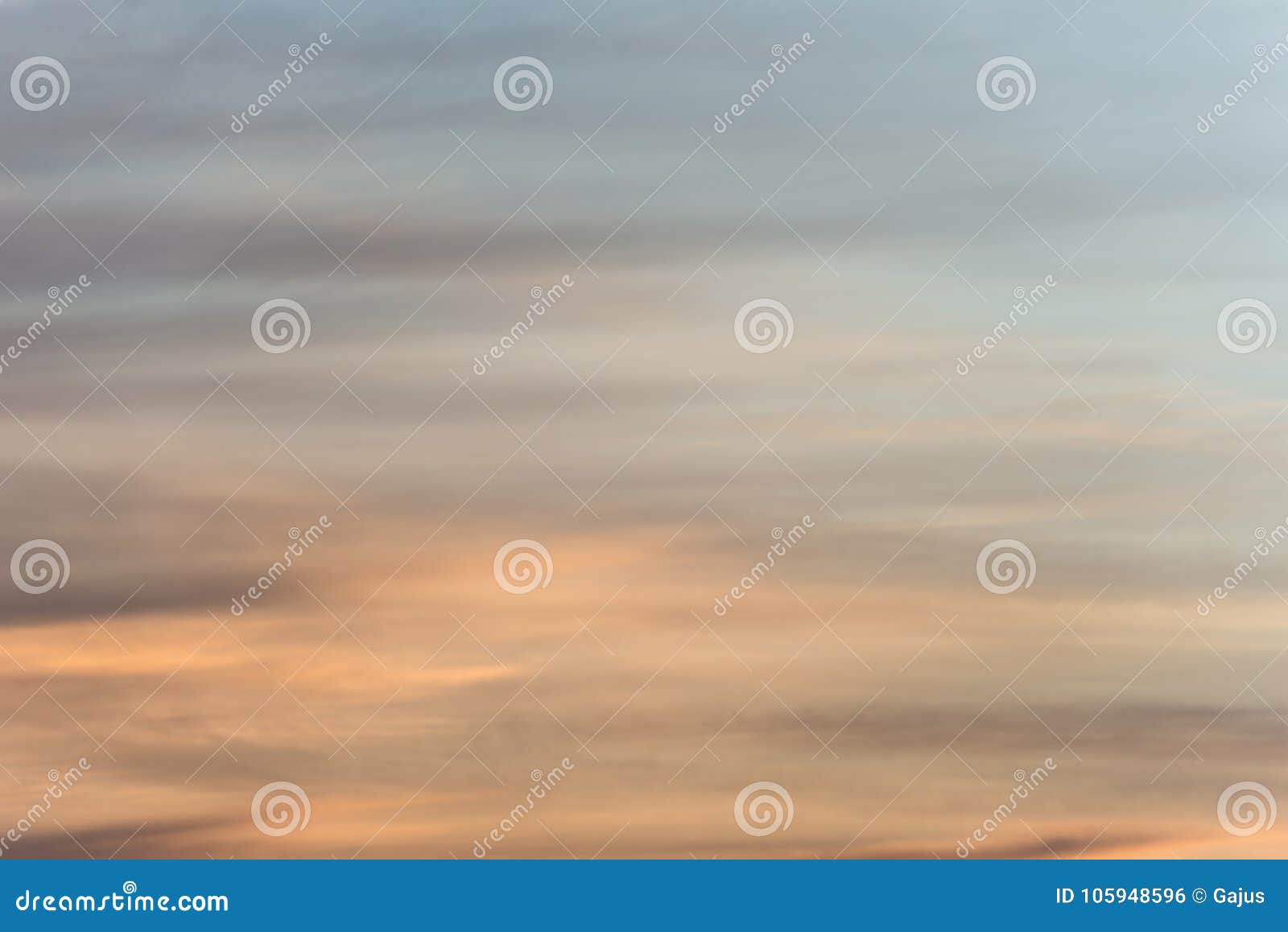sunset sky background with a golden orange glow on a hazy clouds