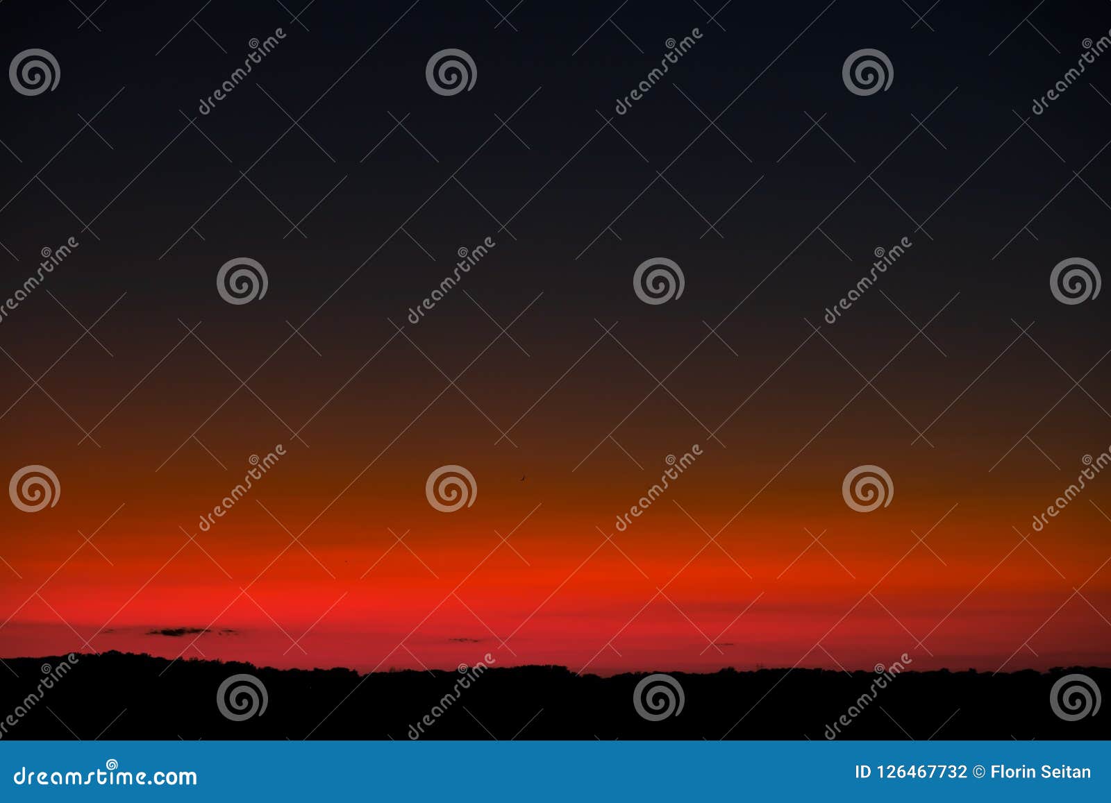 sunset sky with bright red horizon and crescent moon