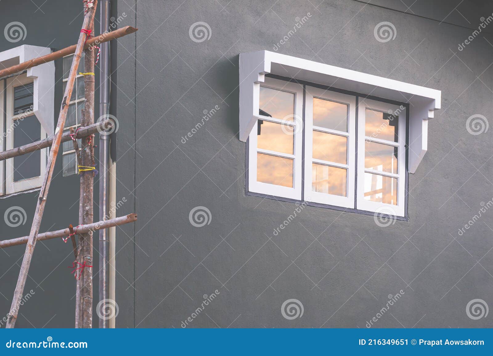 Sunset Sky Reflection on Surface of Glass Window on Gray Cement Wall of