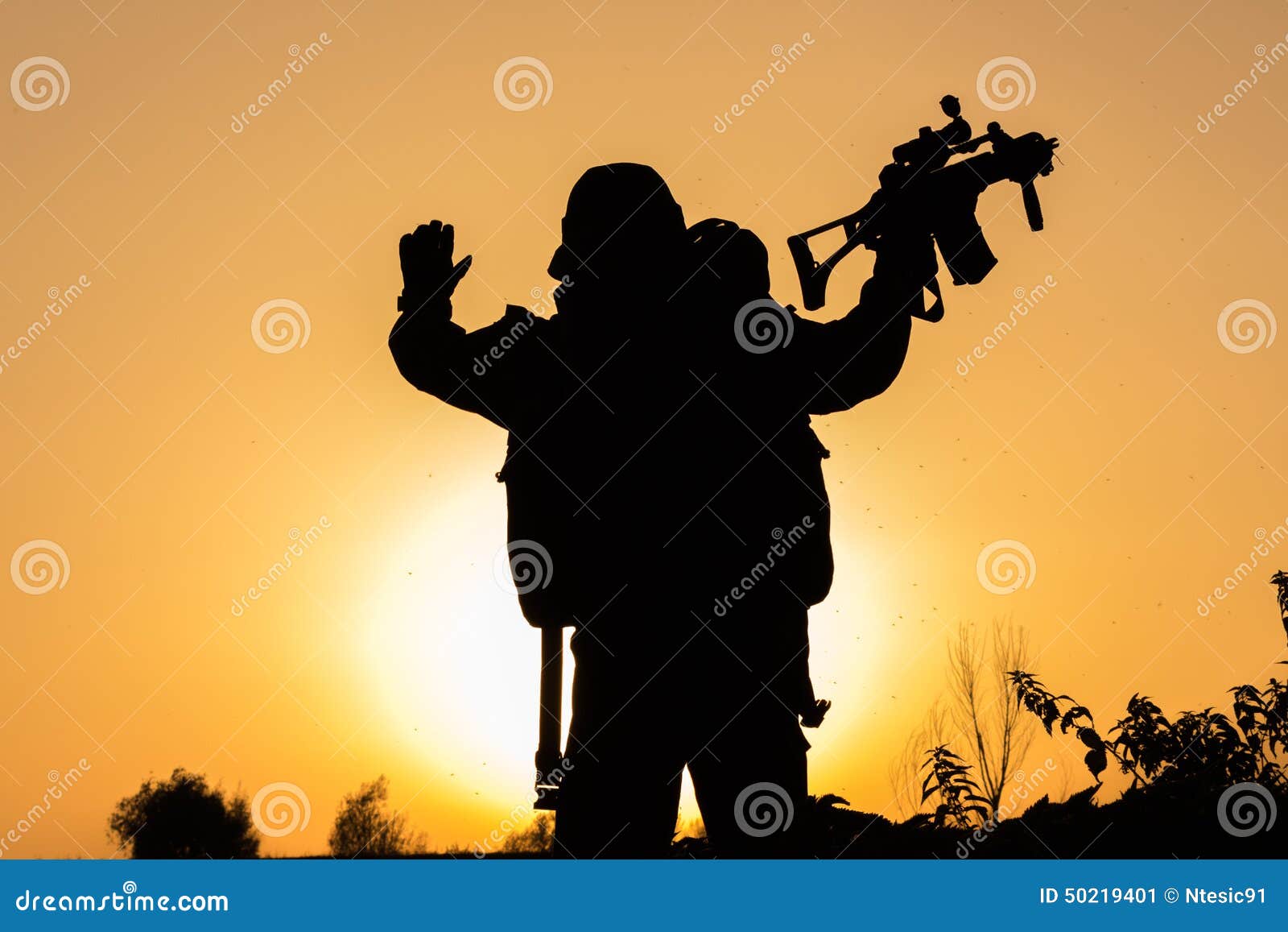 sunset of soldier crouched in uniform