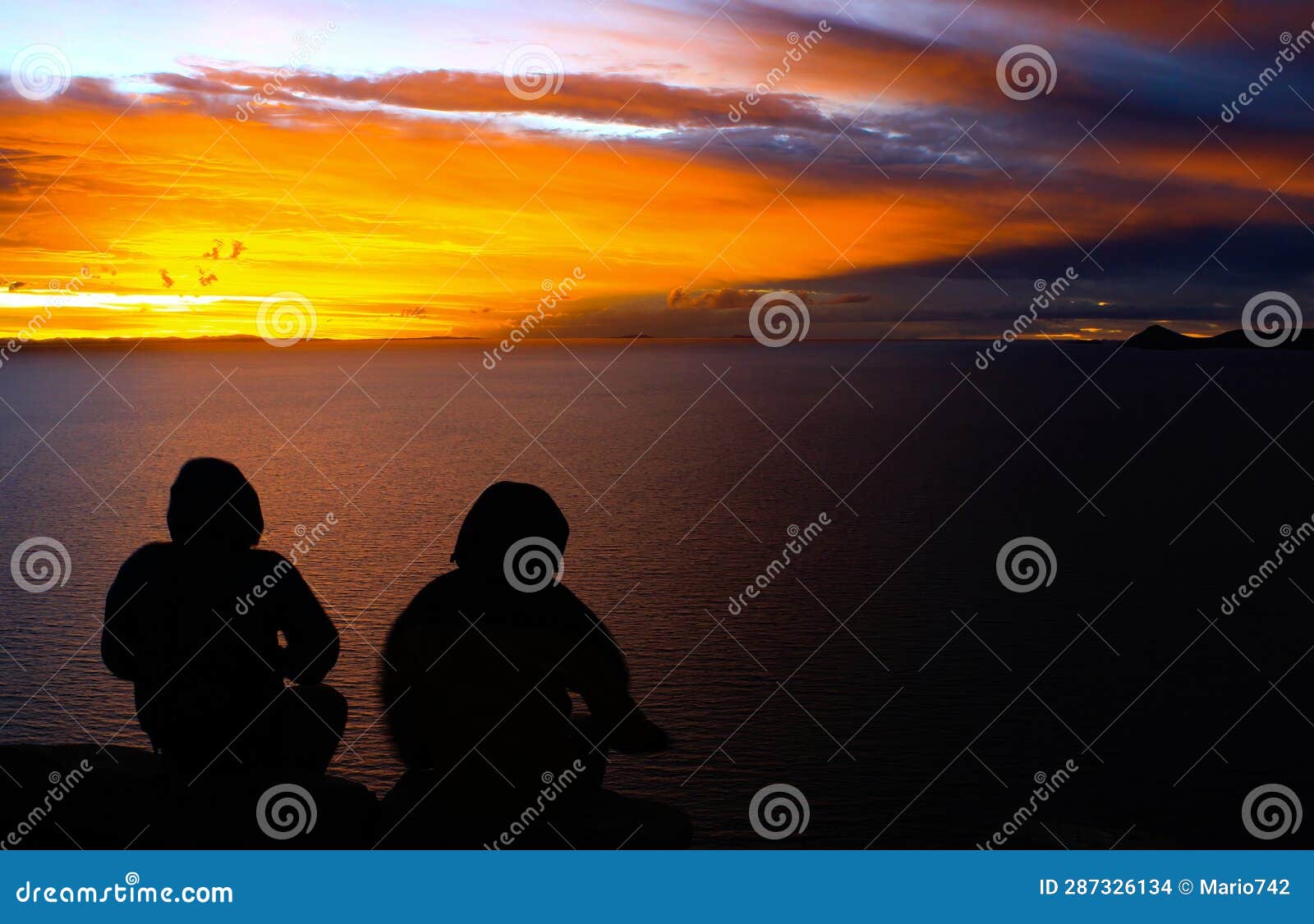 sunset on the titicaca side, being observed by two people
