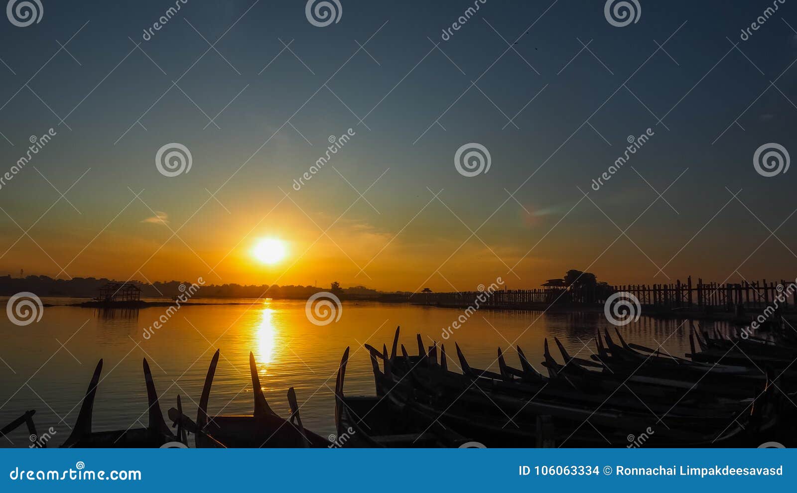 sunset in u bein bridge with vintage boat myanmar. u bein bridge is longest teak