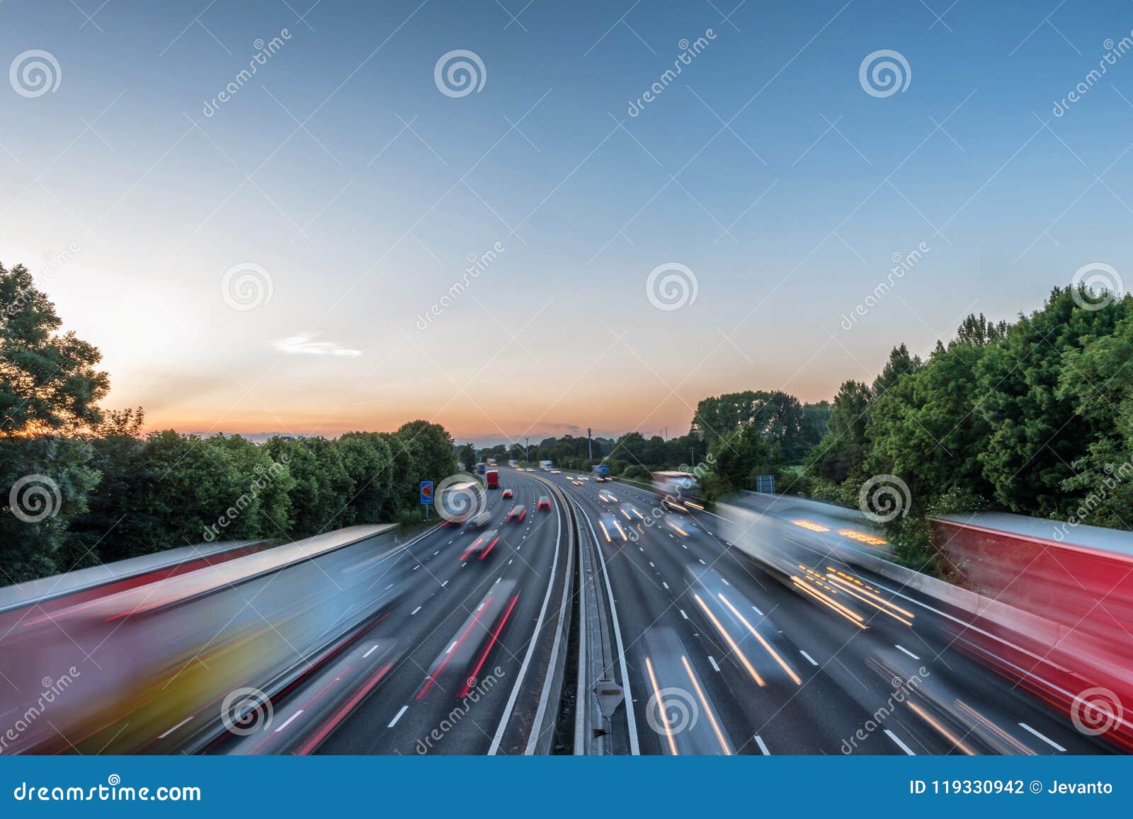 sunset view heavy traffic moving at speed on uk motorway in england