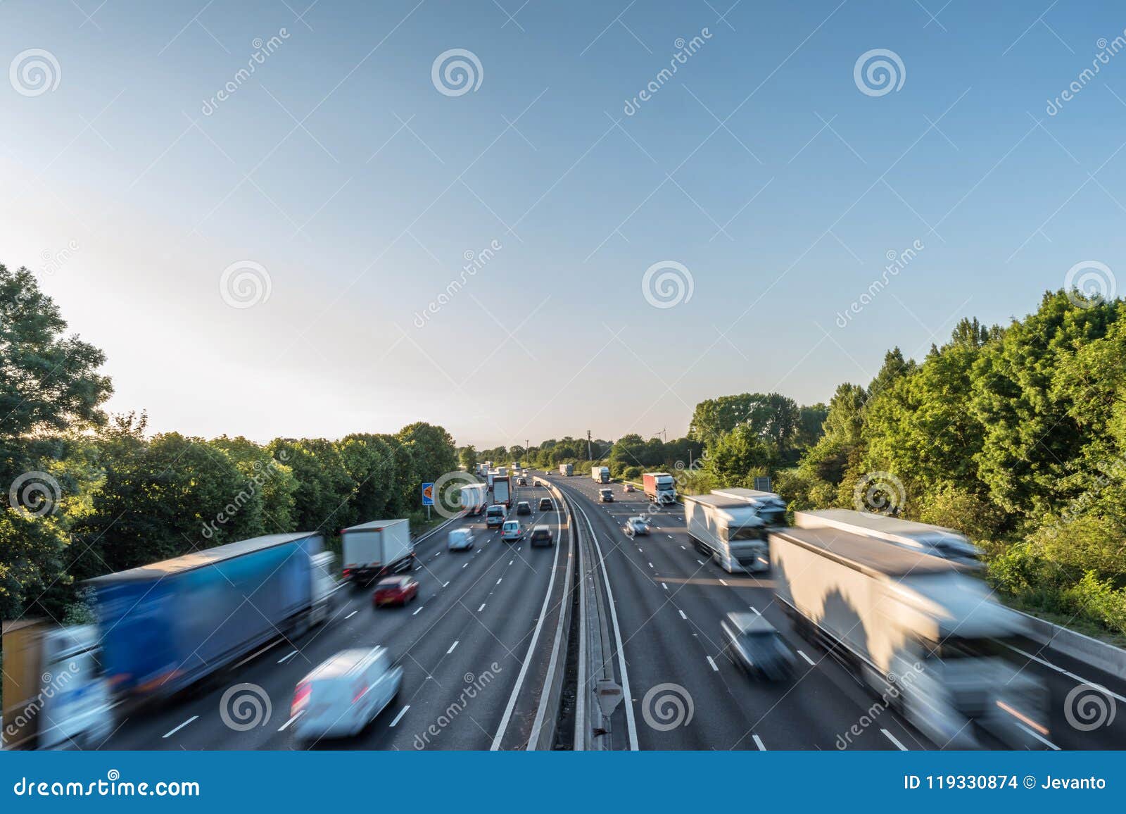 sunset view heavy traffic moving at speed on uk motorway in england