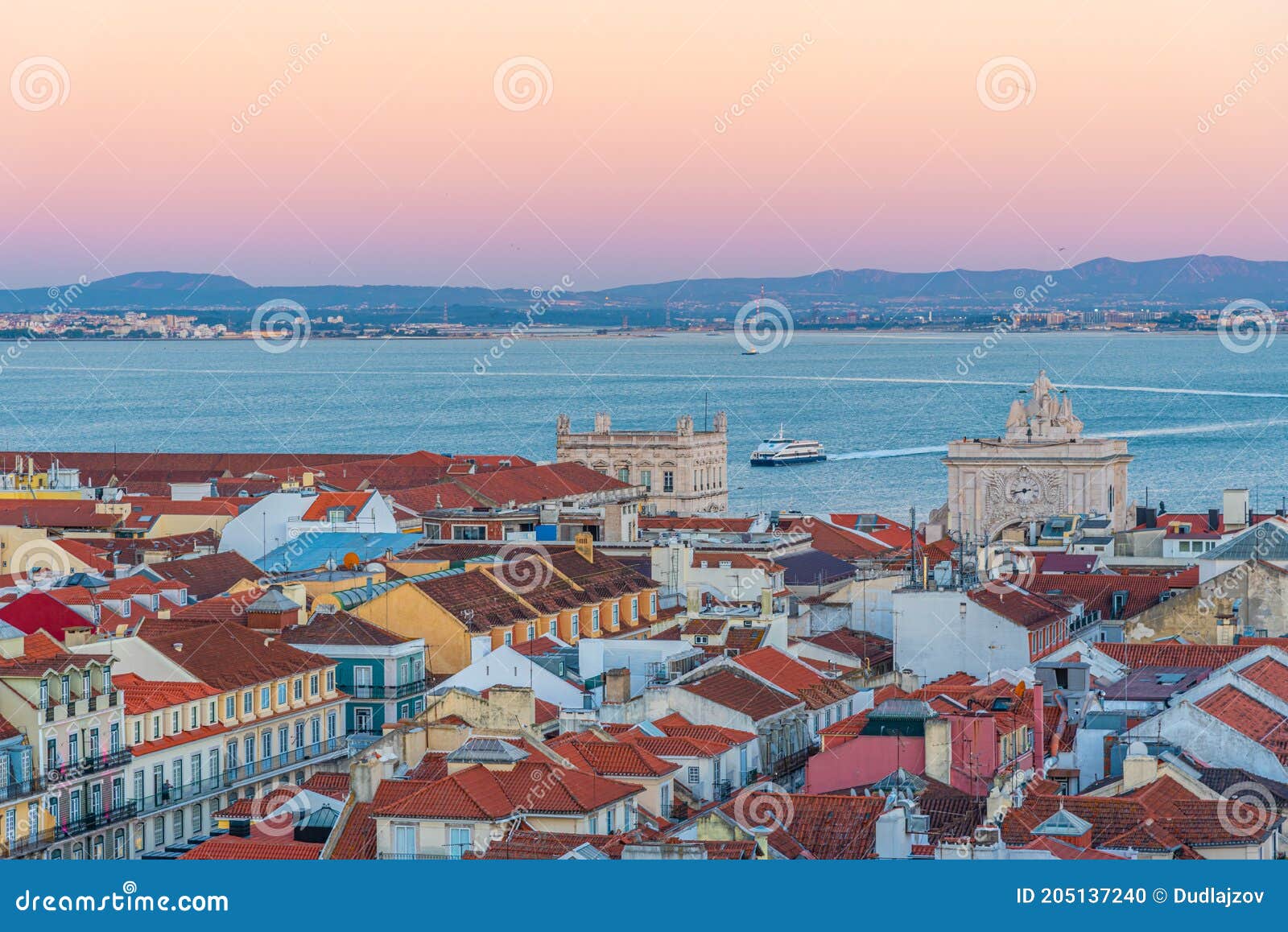 sunset view of the old town and praca do commercio in lisbon, portugal