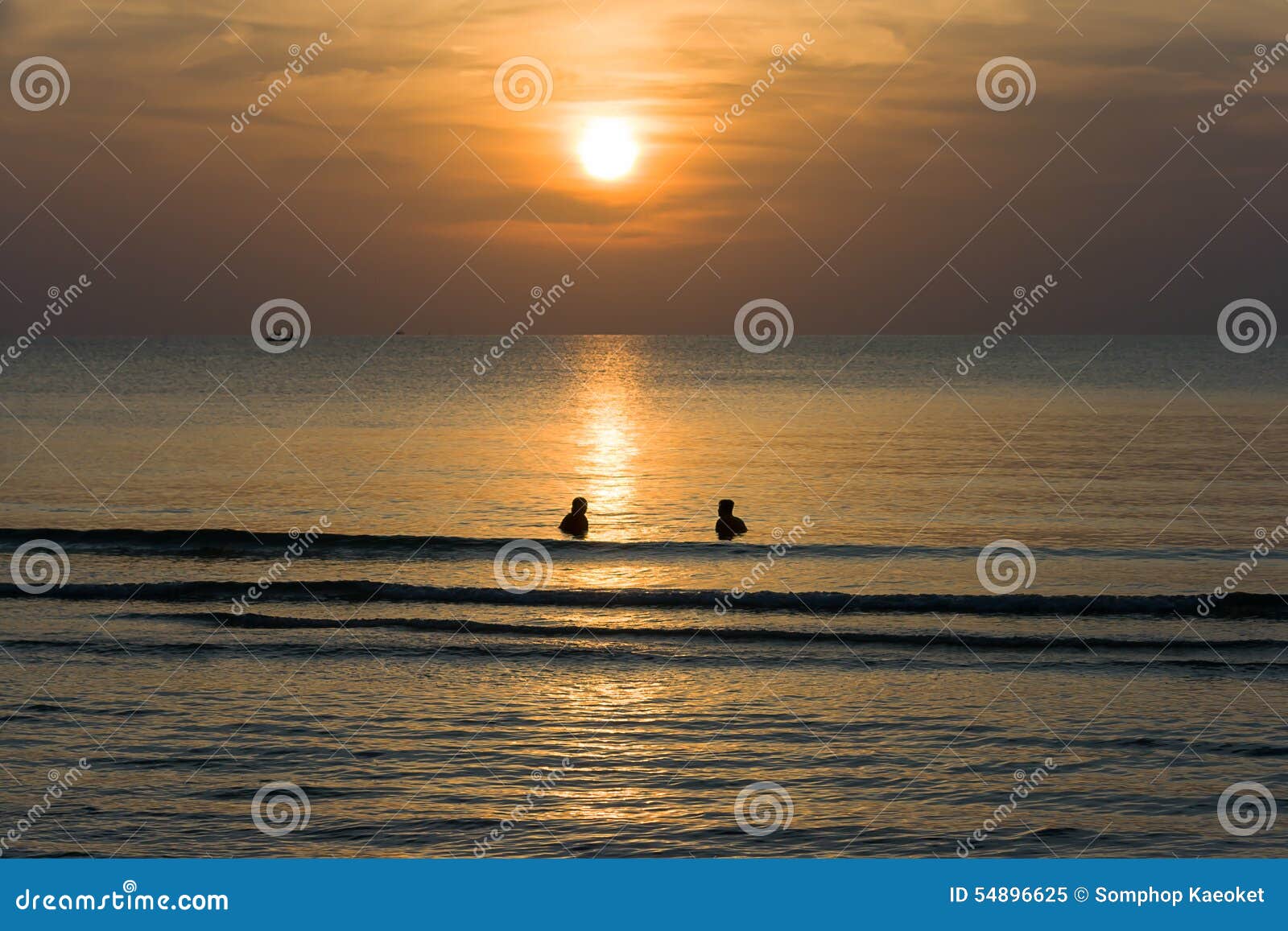 Sunsets at the Sea with Silhouette People in the Water and Clouds and ...