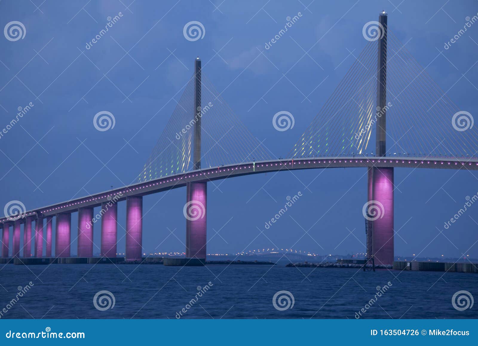 sunshine skyway bridge in tampa bay florida lit in pink lights to commemorate breast cancer awareness month