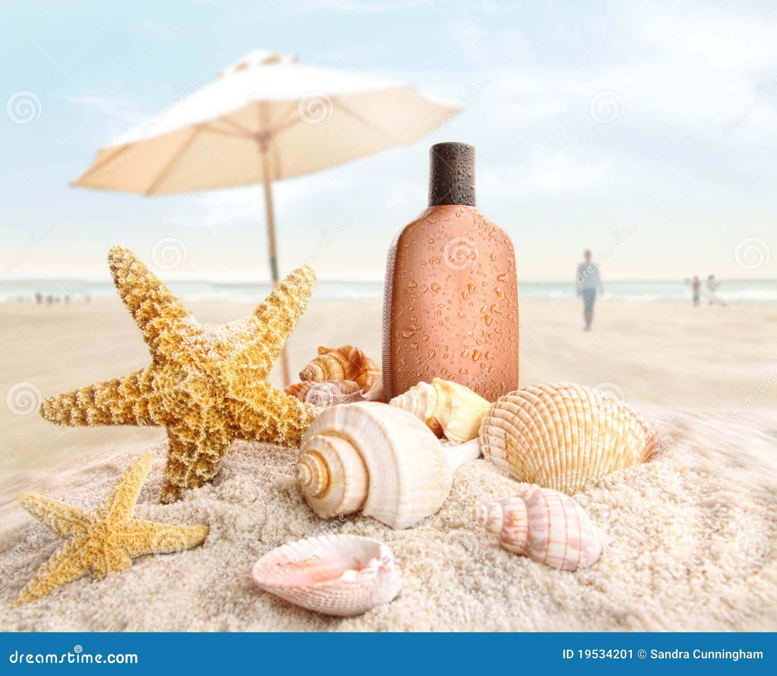 suntan lotion and seashells on the beach