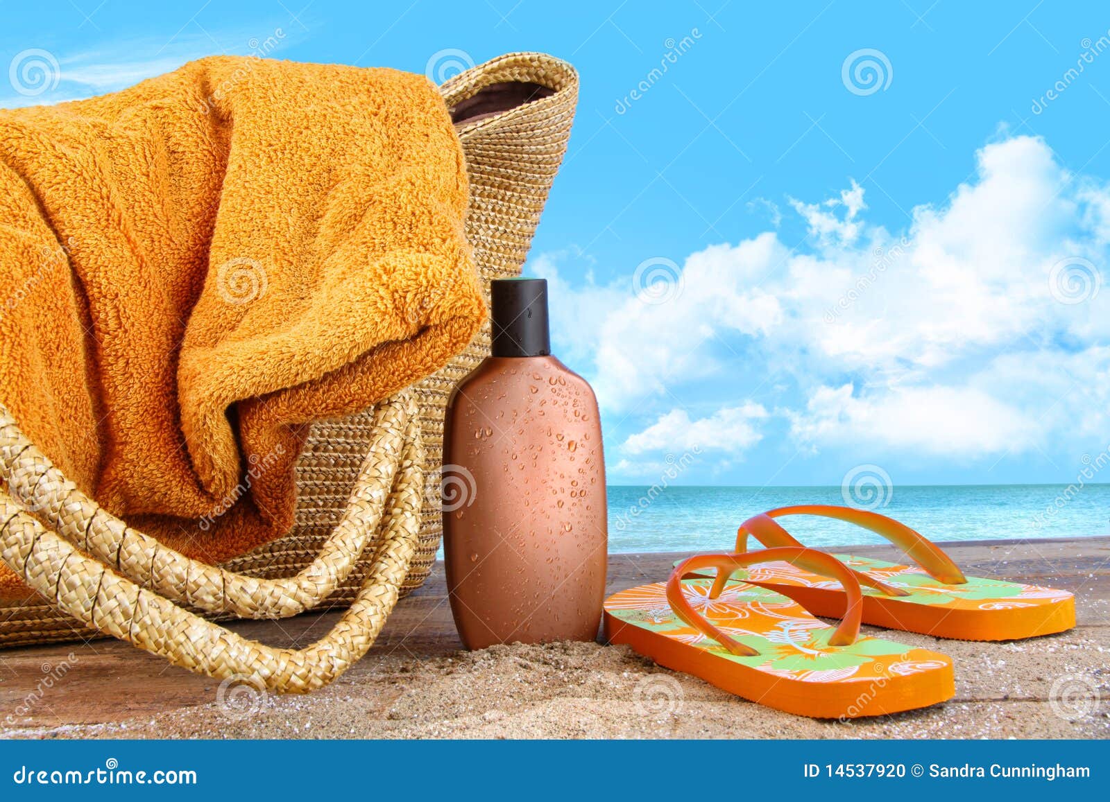 suntan lotion, with towel at the beach