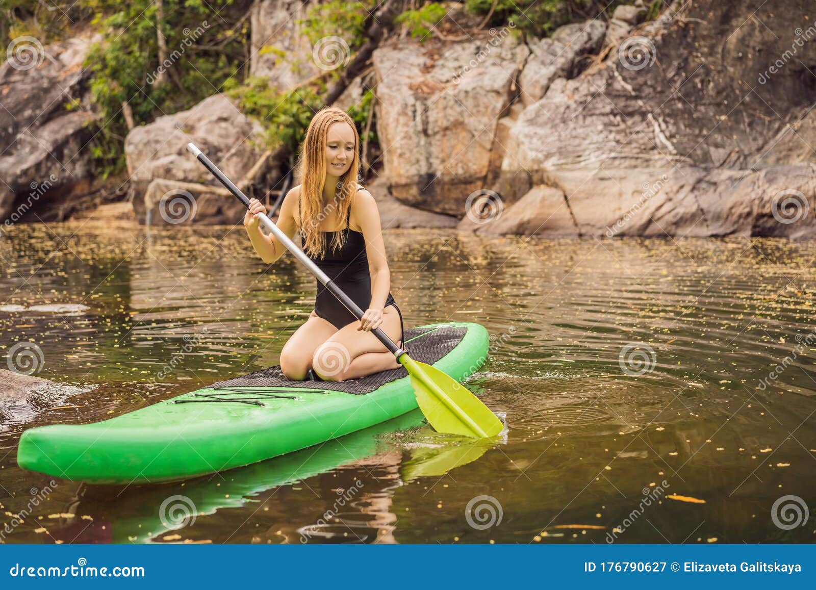 SUP Stand Up Paddle Board Woman Paddle Boarding on Lake Standing Happy ...