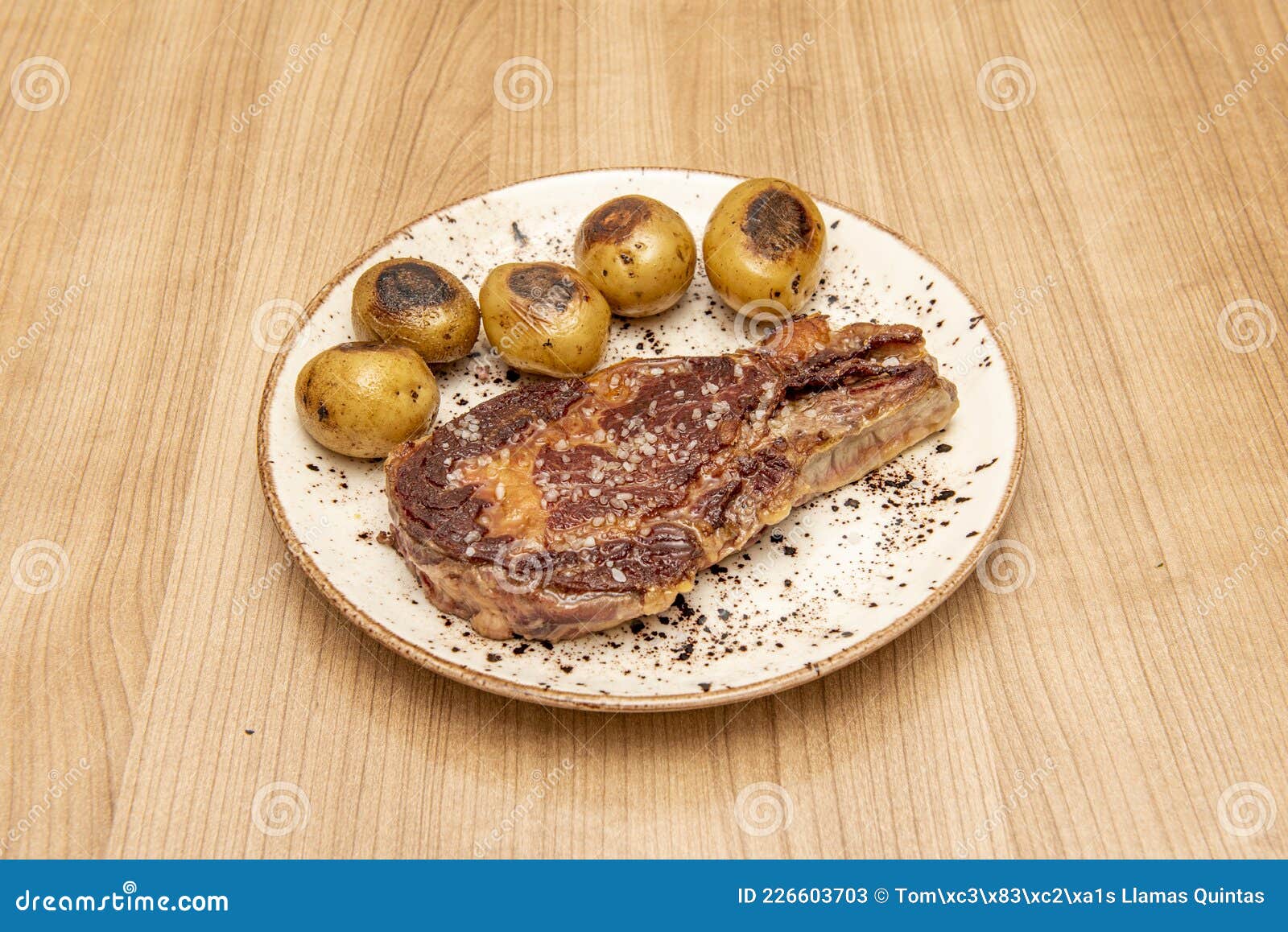 super entrecote with sea salt and seasonal potatoes or cachelos on a white plate