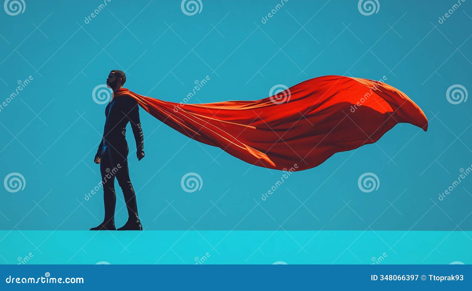superhero striking a powerful pose with a red cape flowing in the wind against a blue backdrop