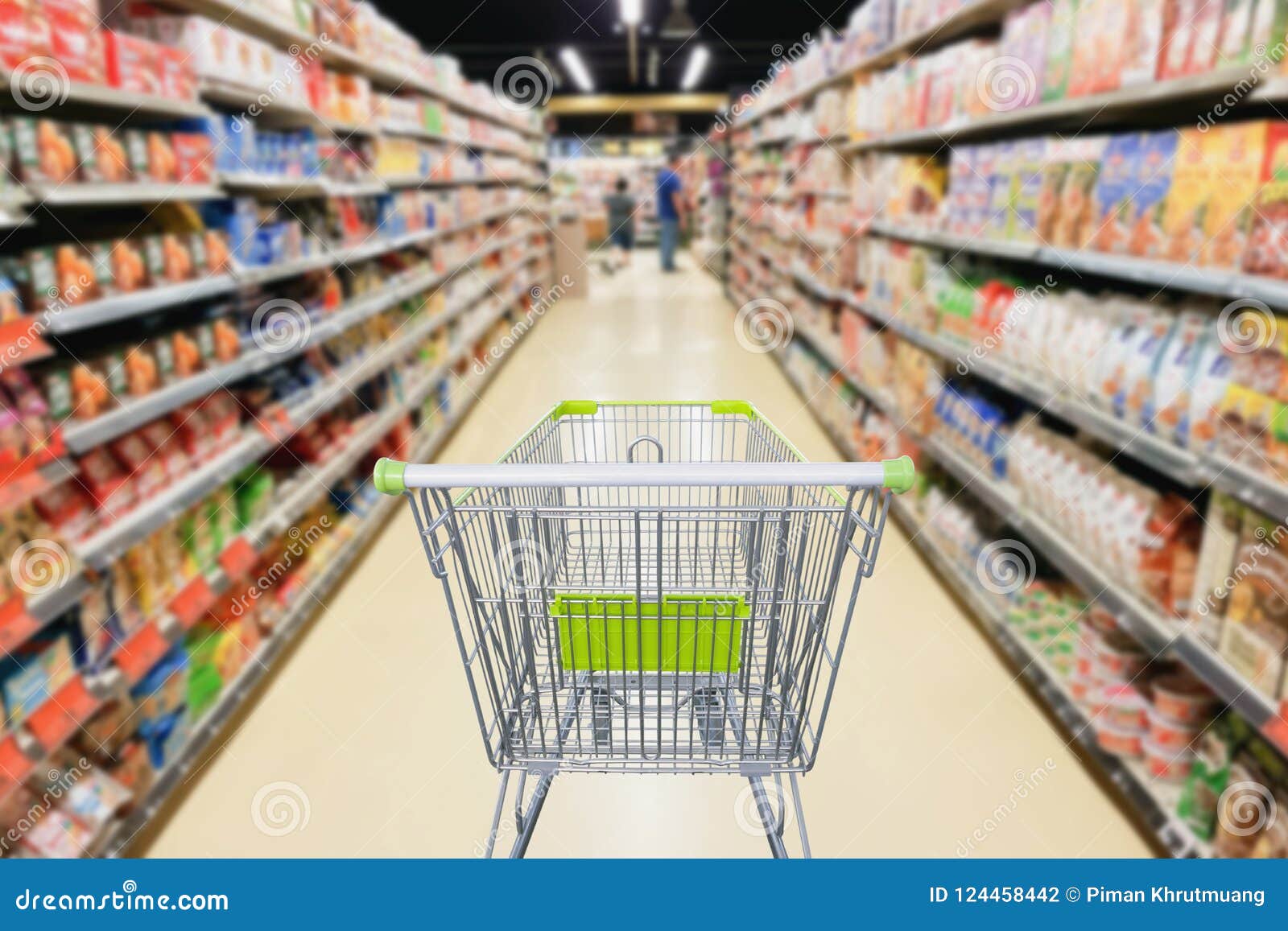 Supermarket Aisle With Empty Shopping Cart At Grocery Store Stock Photo
