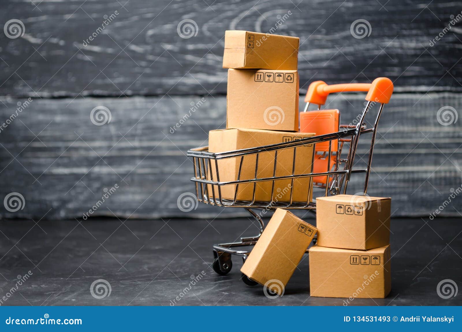 a supermarket cart loaded with cardboard boxes. sales of goods. concept of trade and commerce, online shopping. high. delivery