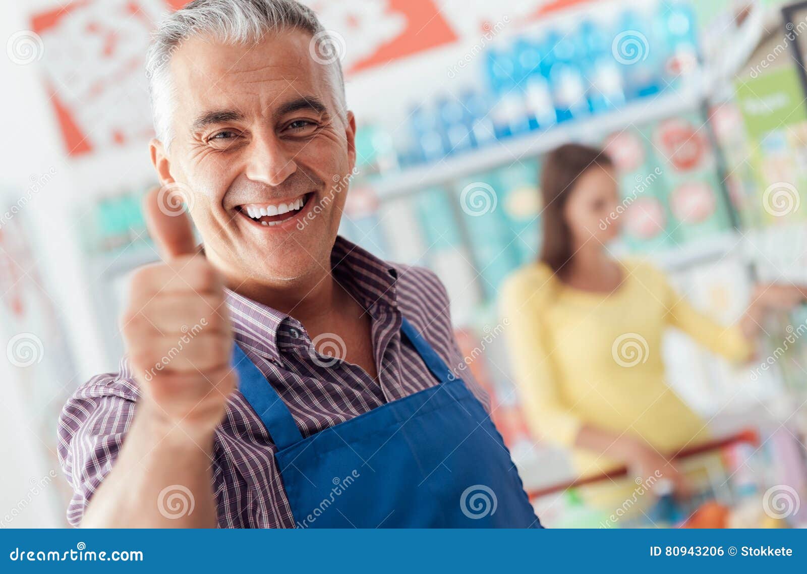 supermarket clerk giving a thumbs up