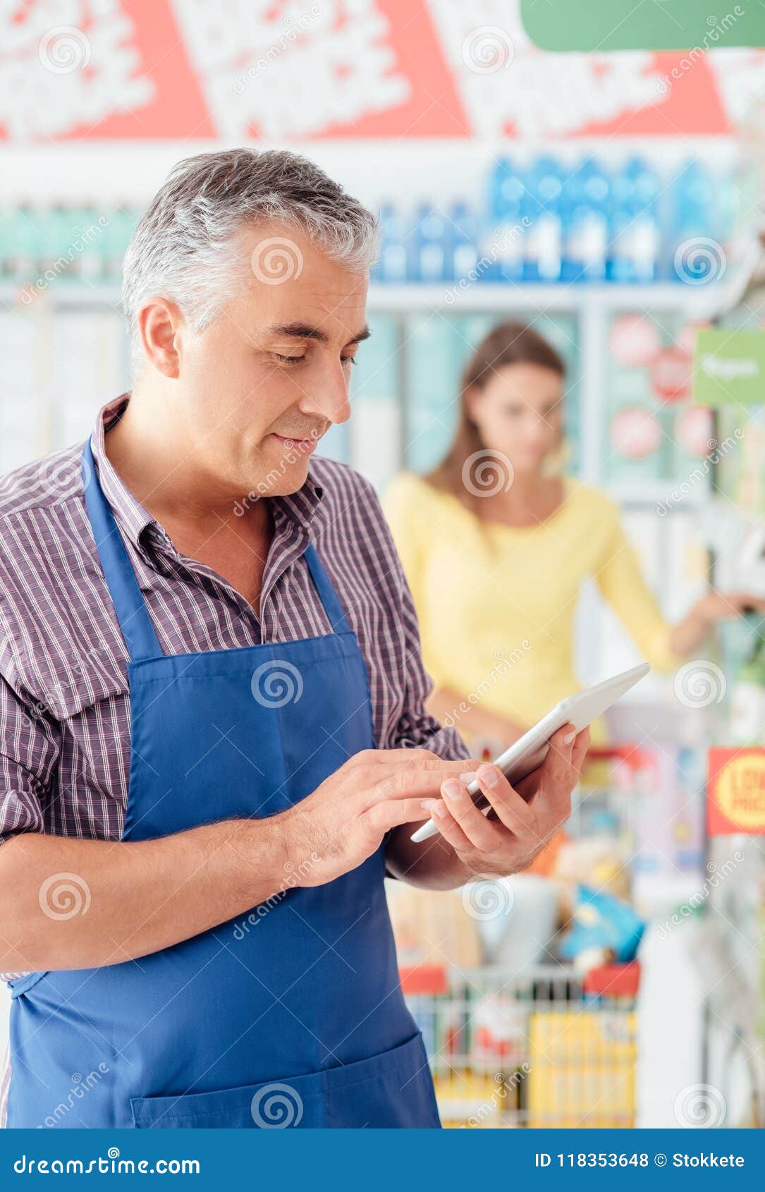 supermarket clerk using a tablet