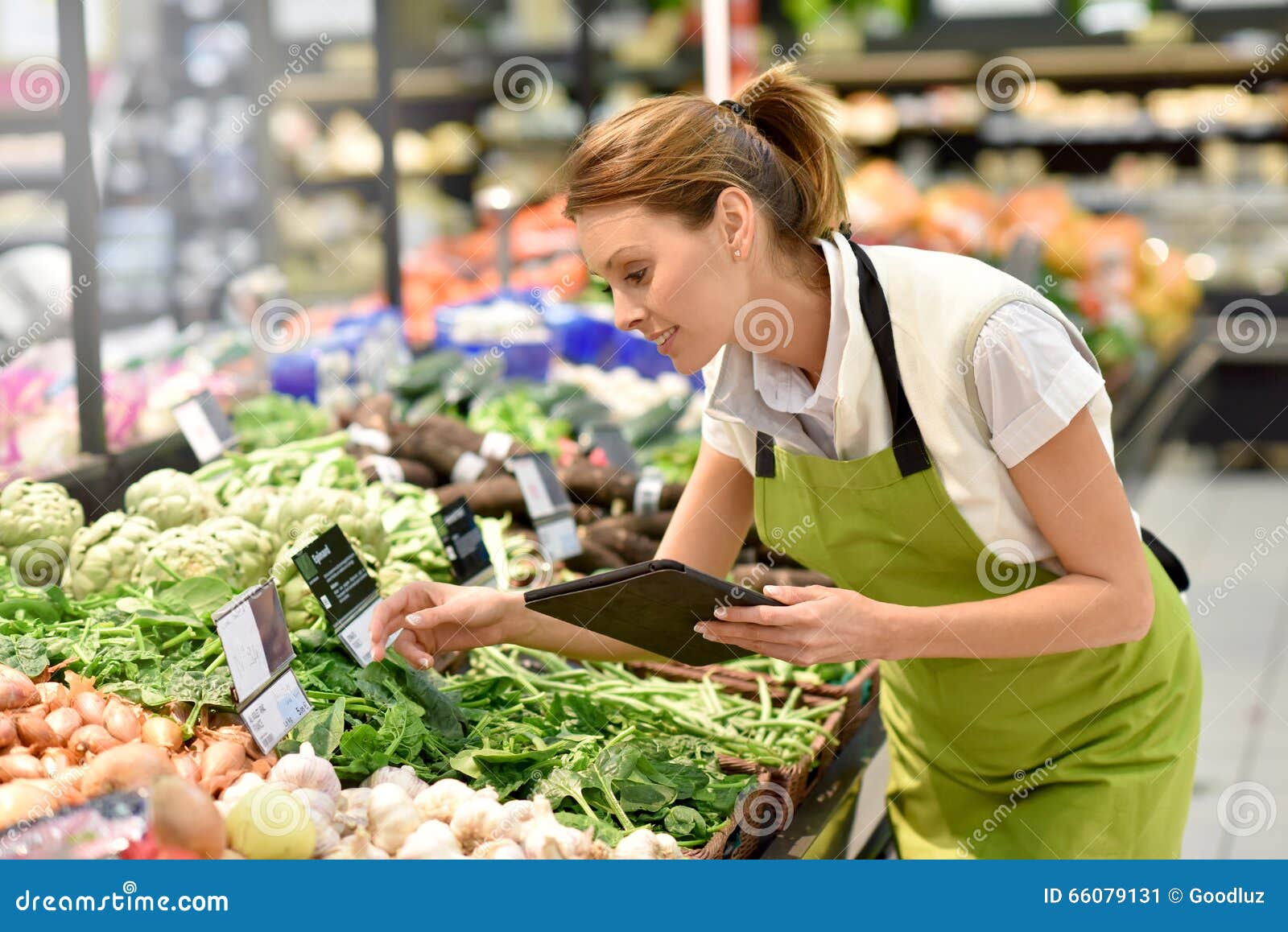 supermarket employee in vegetable section