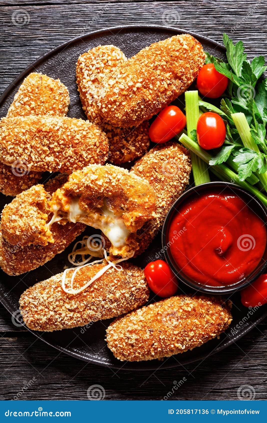 suppli al telefono on a black plate, top view