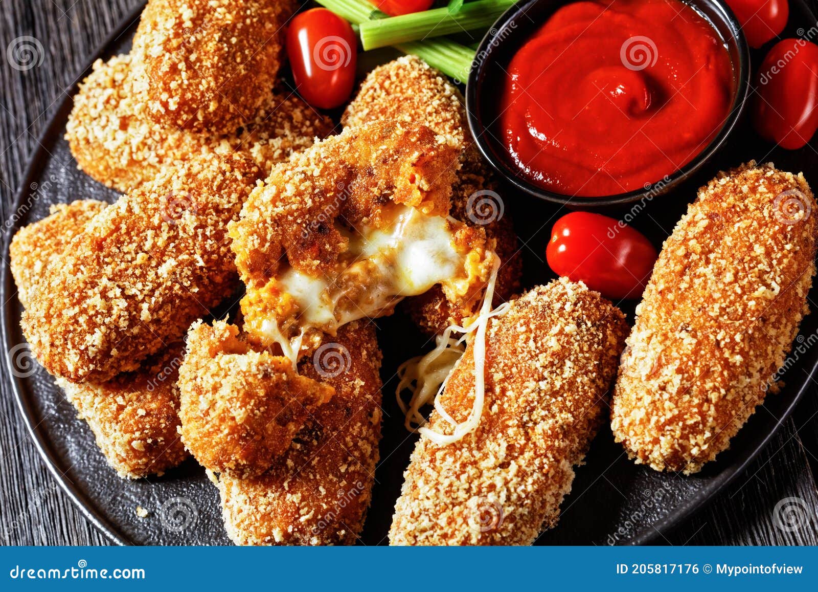 suppli al telefono on a black plate, top view