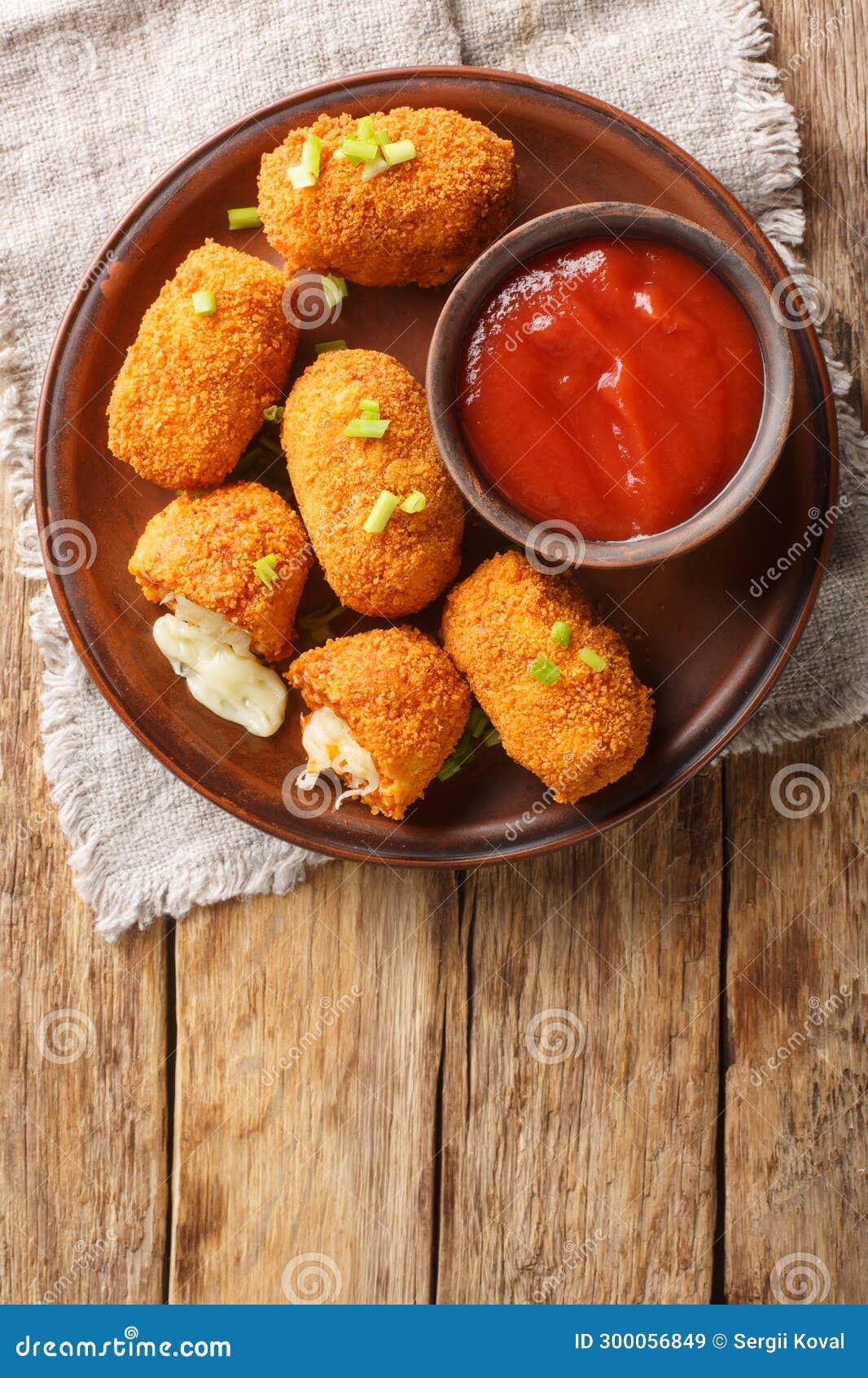 suppli al telefono italian fast food fried tomato rice croquettes stuffed with mozzarella closeup on the plate. vertical top view